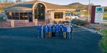 2023 Phillips Outdoor Services Team Photo in front of the main office featuring our Outdoor Display Garden.