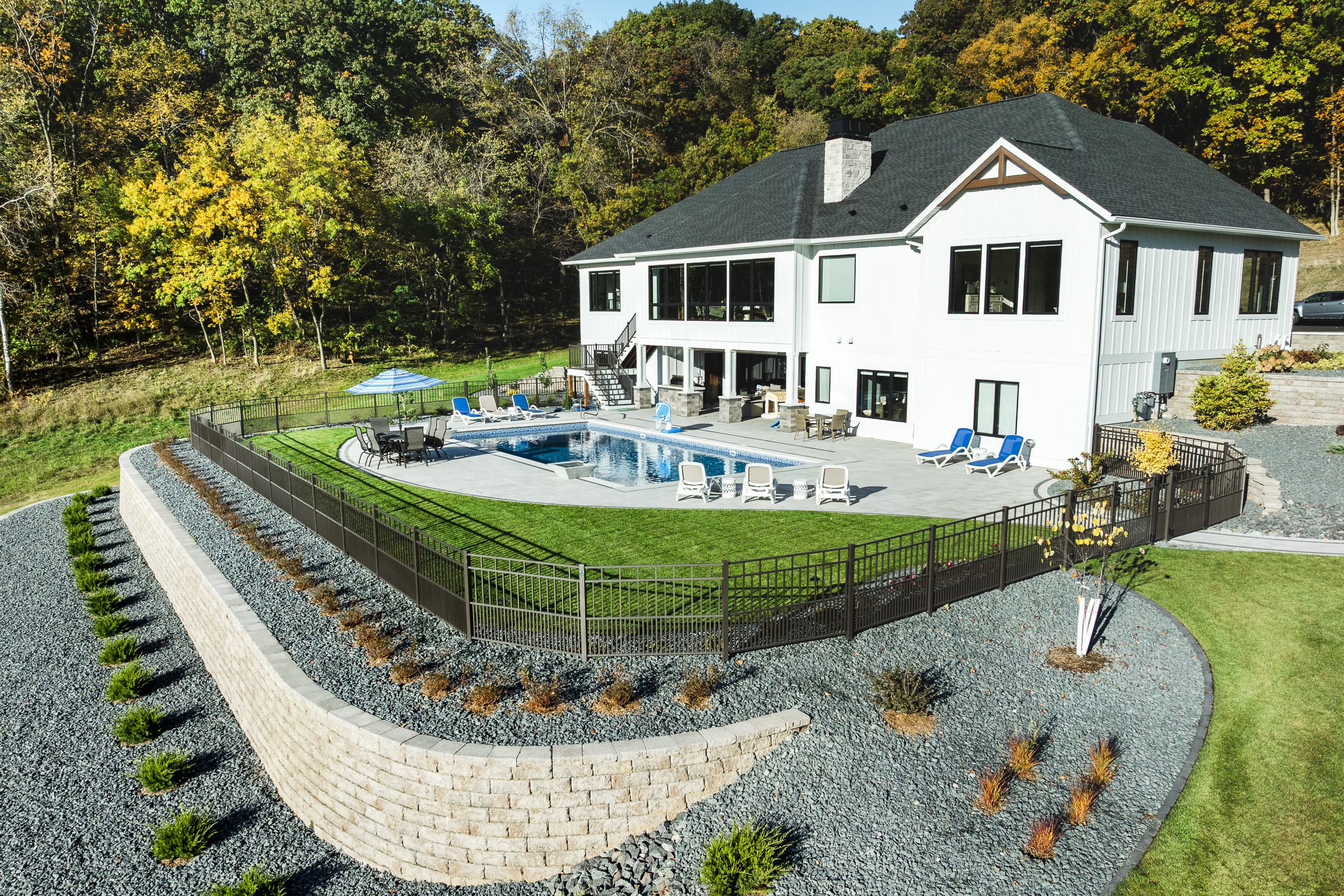 Modern white house with backyard pool and patio
