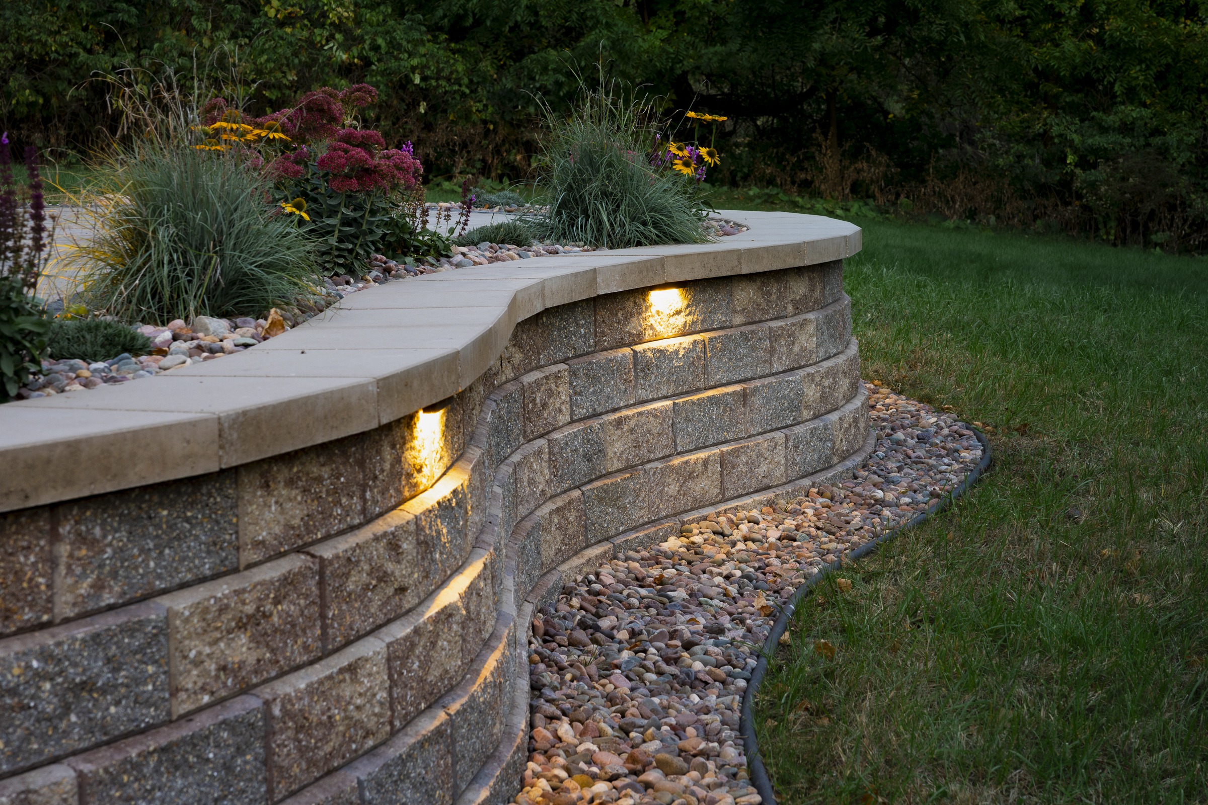 Curved stone retaining wall with built-in lights
