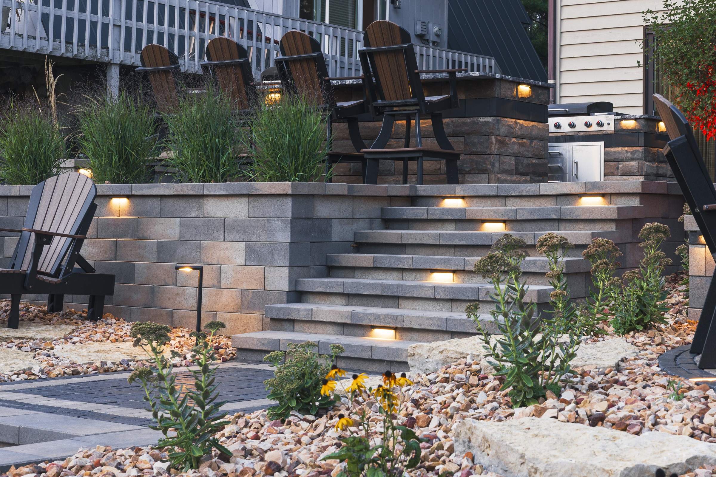 Modern backyard patio with lit stone steps