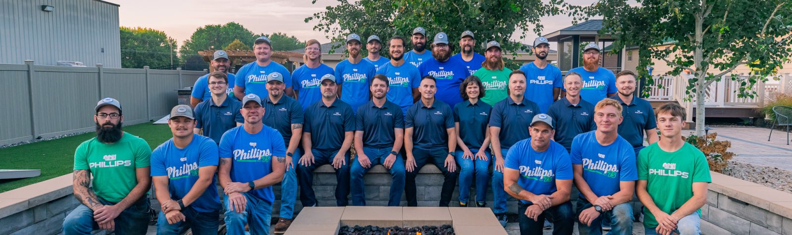 Team members posing outdoors in branded Phillips shirts