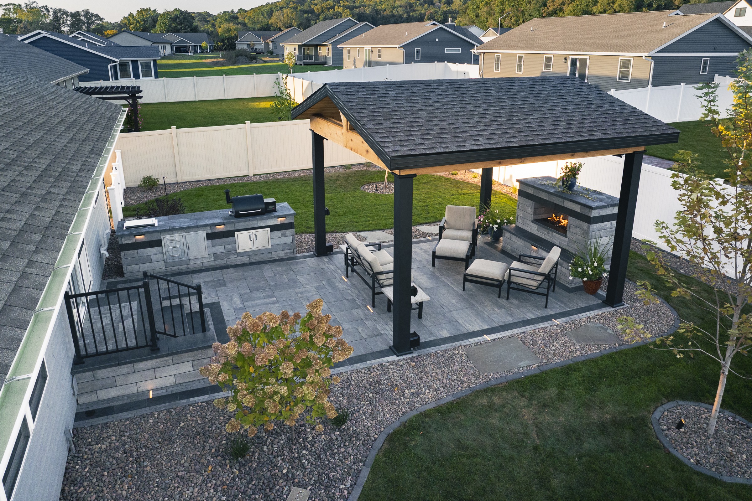 Modern backyard patio with pergola and fireplace