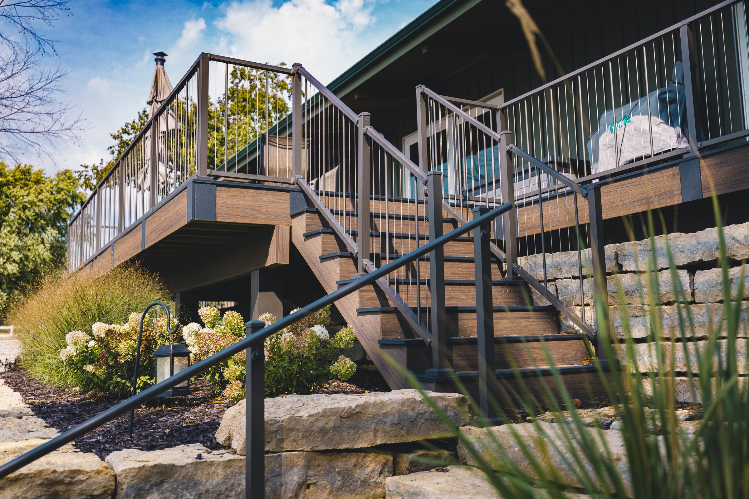 Elevated backyard deck with stairs and metal railing