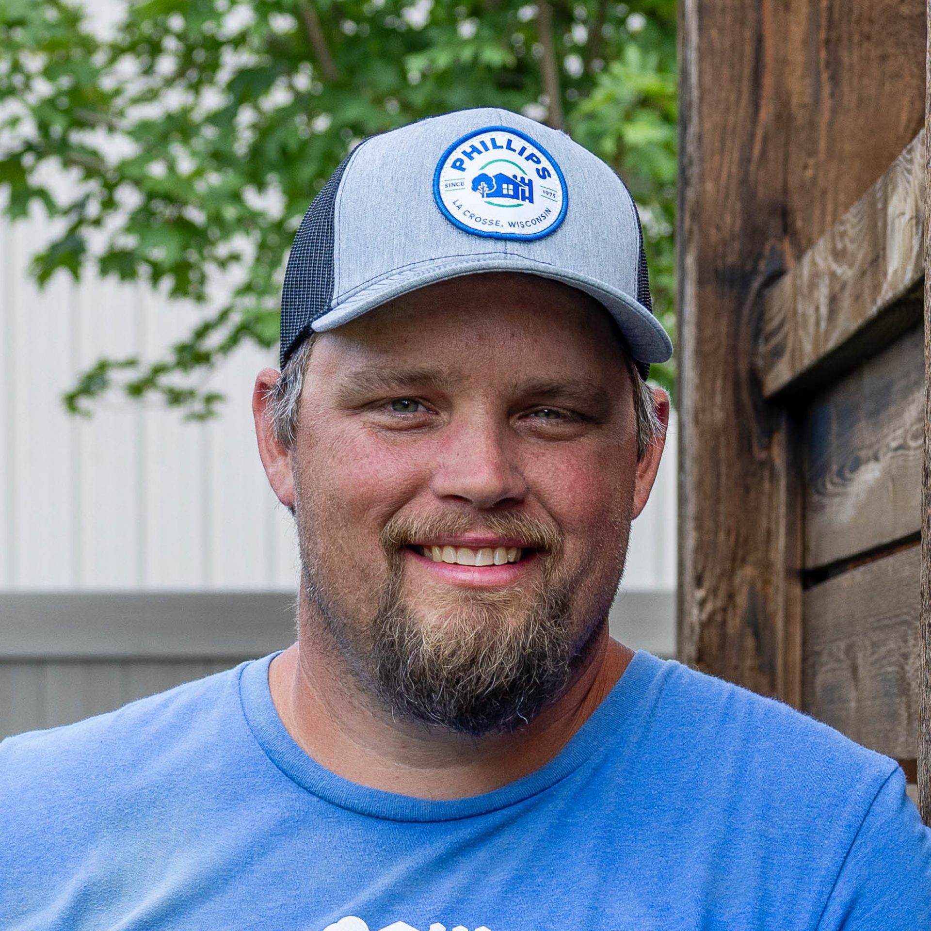 Smiling man in gray cap outdoors