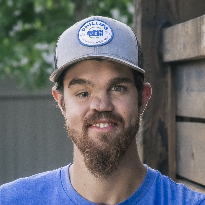 Smiling bearded man wearing Phillips baseball cap