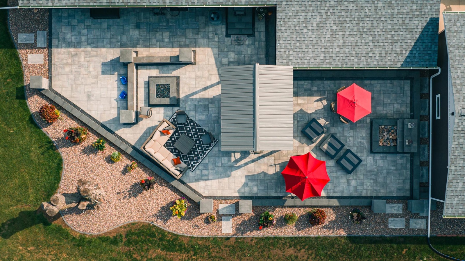 Aerial view of modern backyard patio with red umbrellas