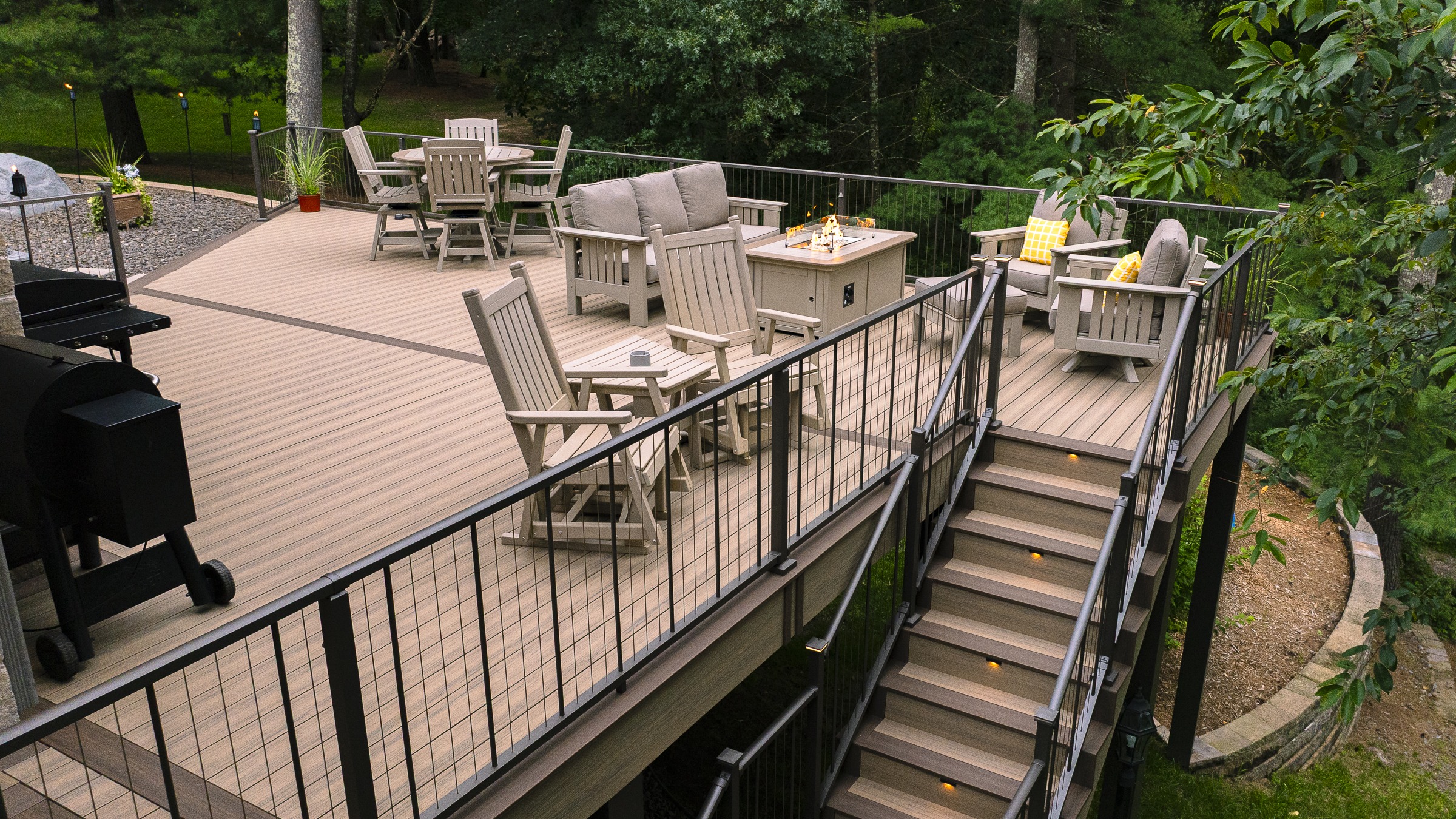 Spacious backyard deck with seating and fire pit