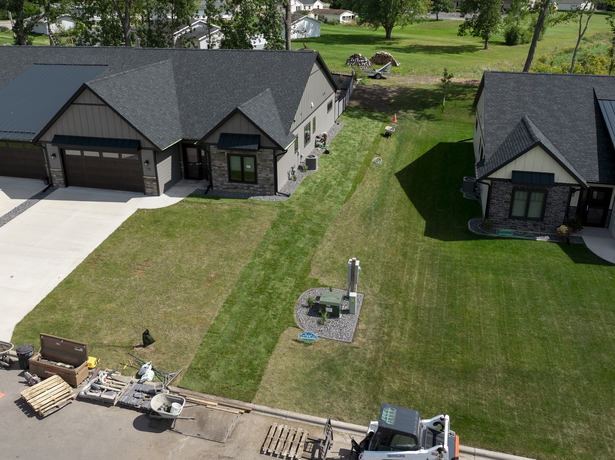 Aerial view of suburban duplex and lawn landscaping