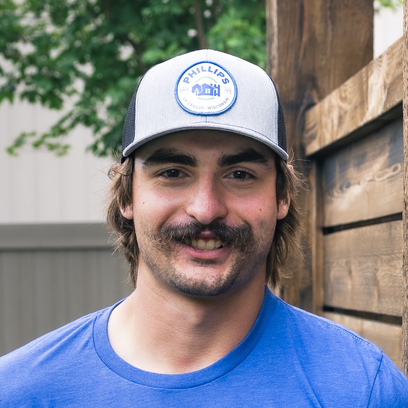 Man wearing Phillips cap smiling outdoors