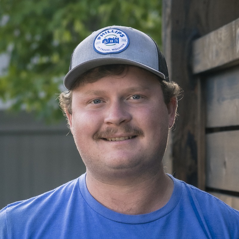 Smiling man wearing gray cap and blue shirt