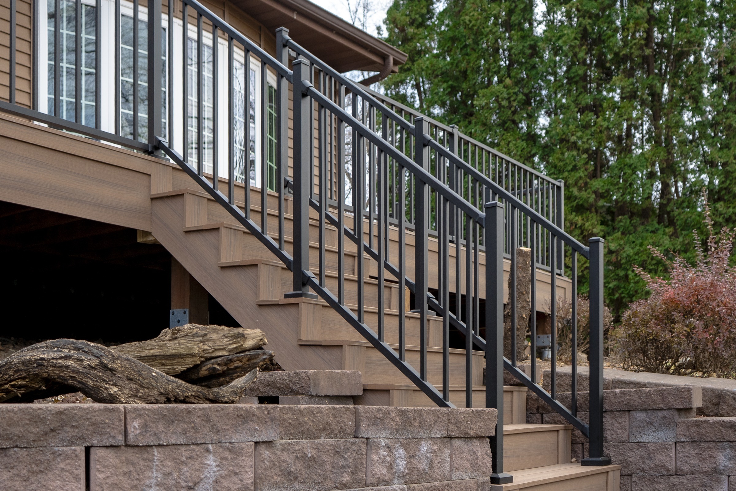 Wooden deck stairs with black metal railing