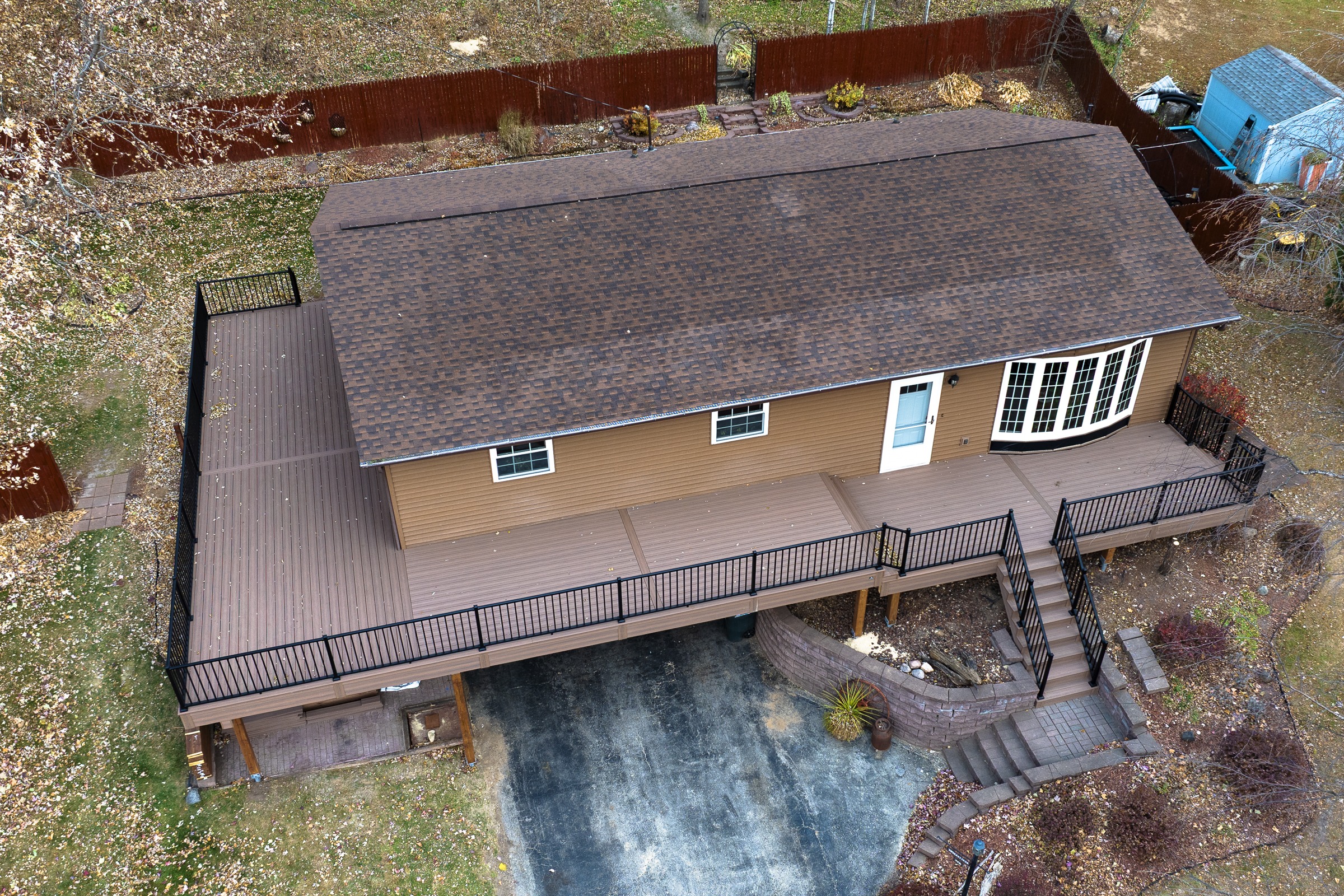 Aerial view of house with large wooden deck