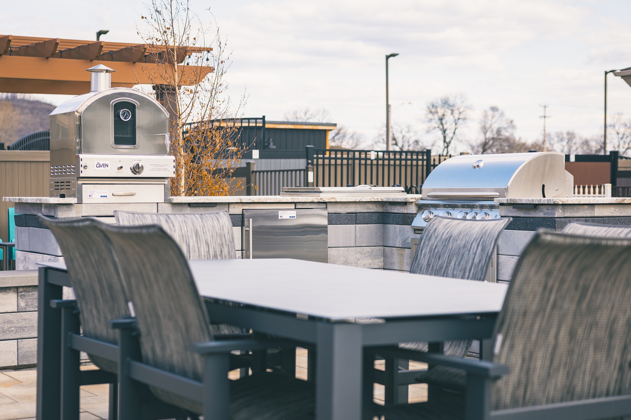 Outdoor kitchen with pizza oven and grill