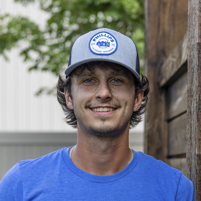 Smiling man in gray cap outdoors