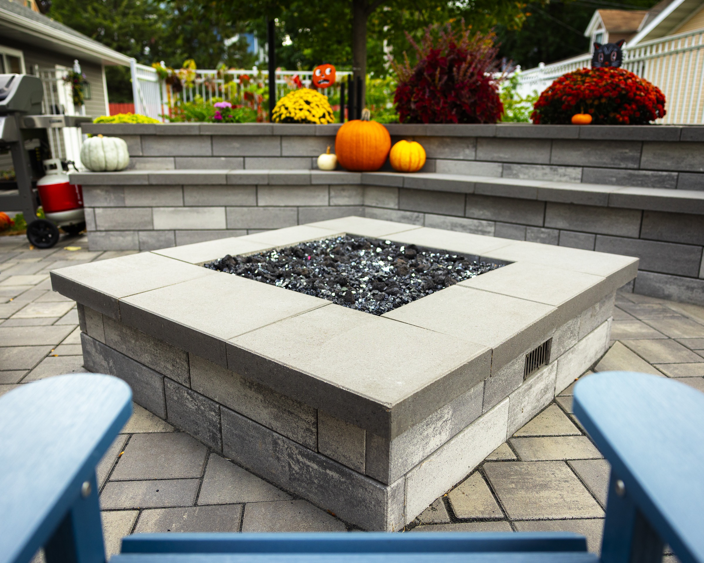 Backyard patio fire pit with fall decorations