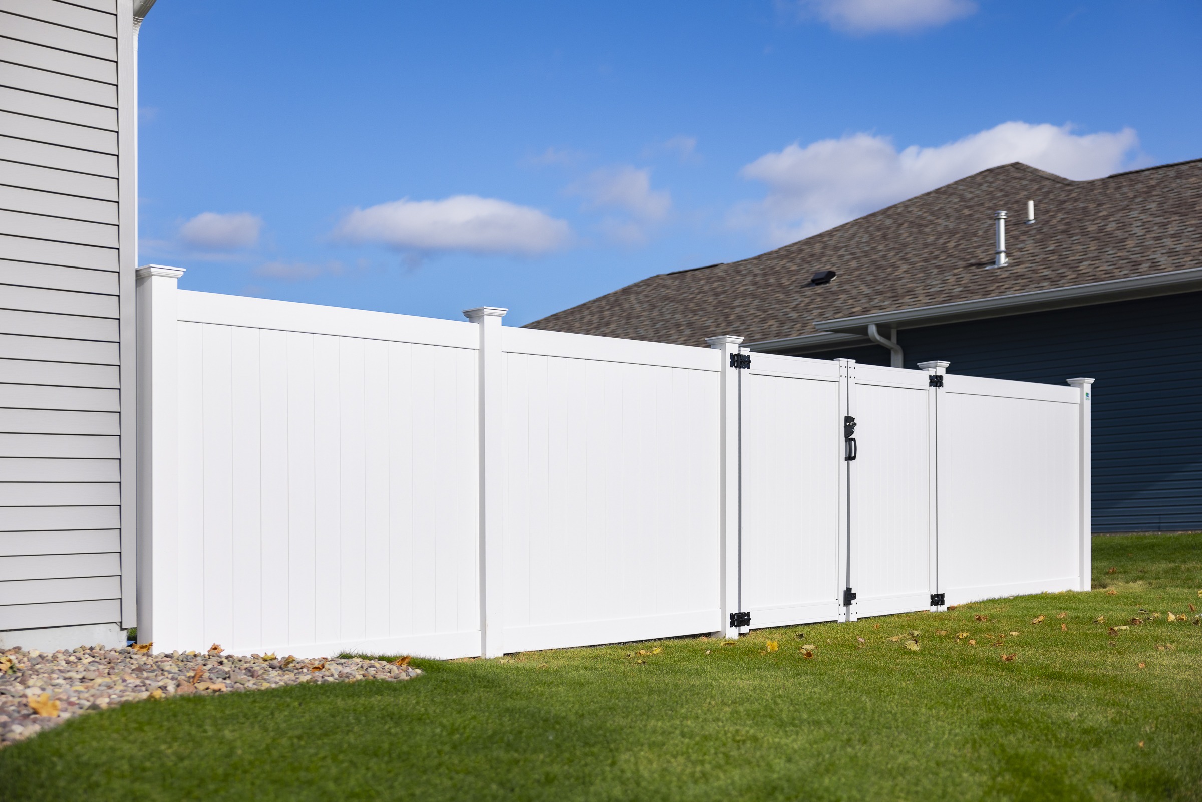 White vinyl privacy fence with backyard gate