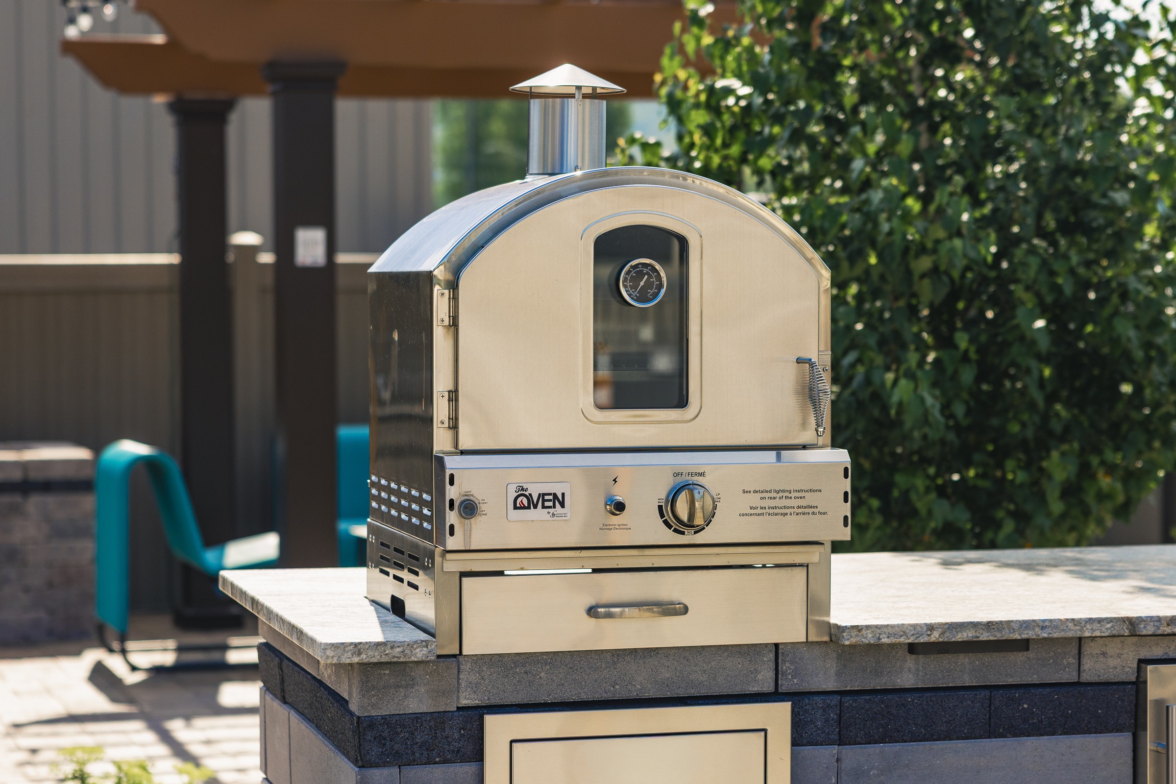 Stainless steel outdoor pizza oven on patio counter