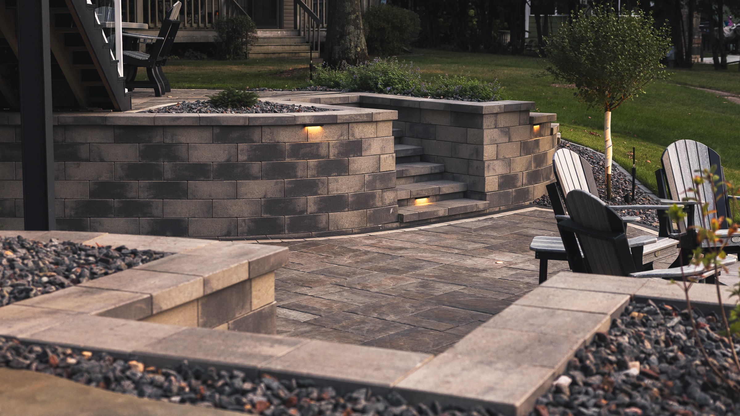 Modern stone patio with steps and built-in lighting