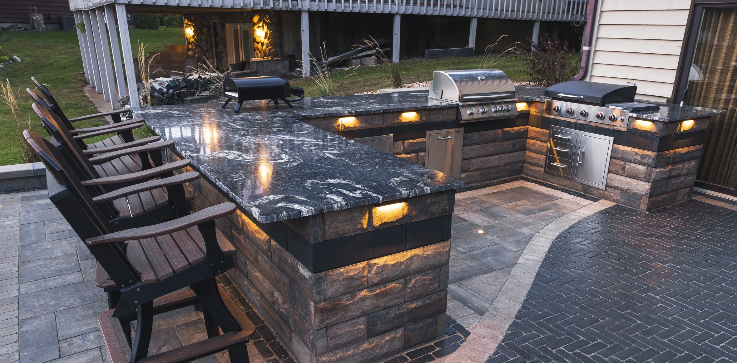Outdoor kitchen with granite bar and built-in grills