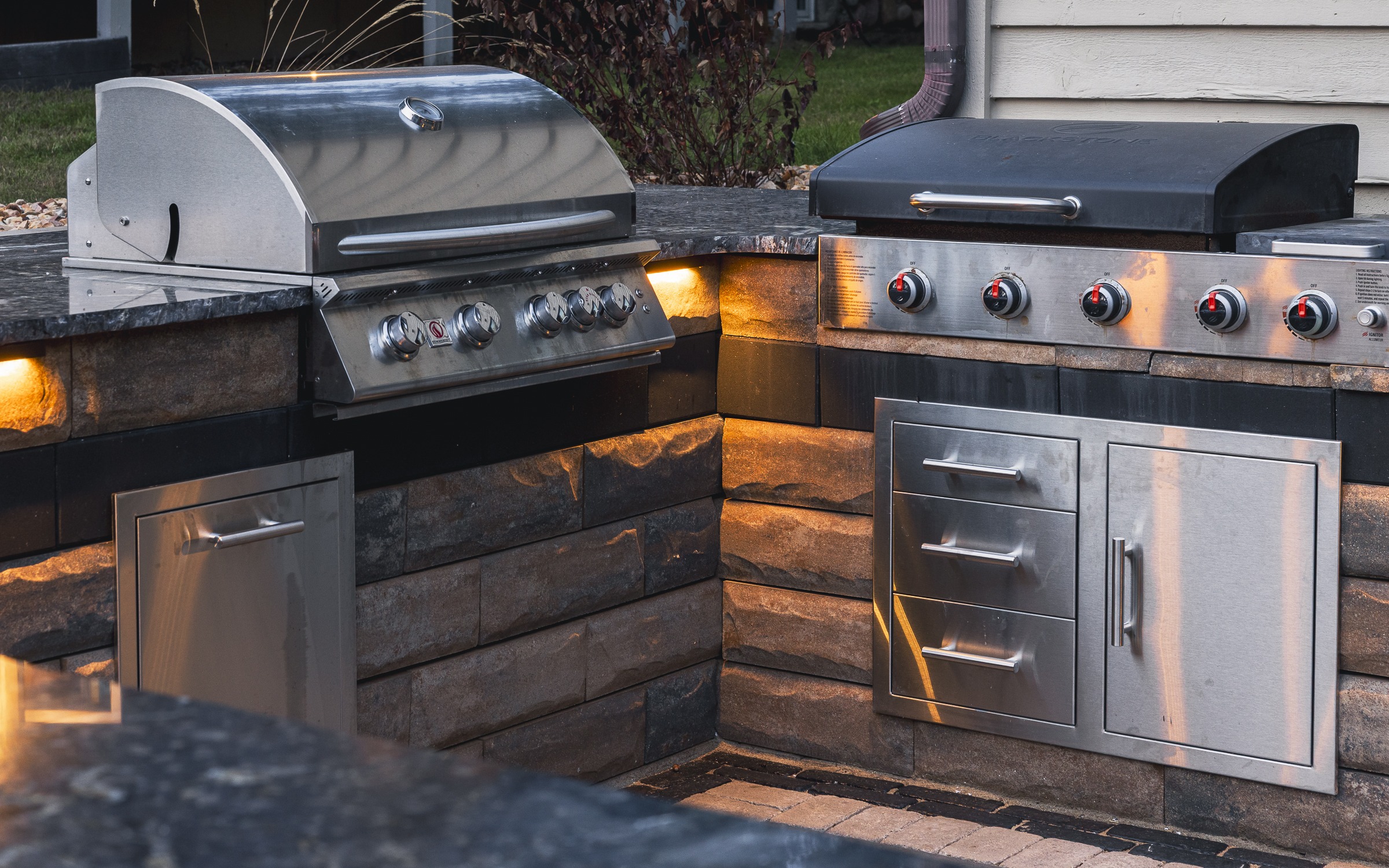 Modern outdoor kitchen with stainless steel gas grills