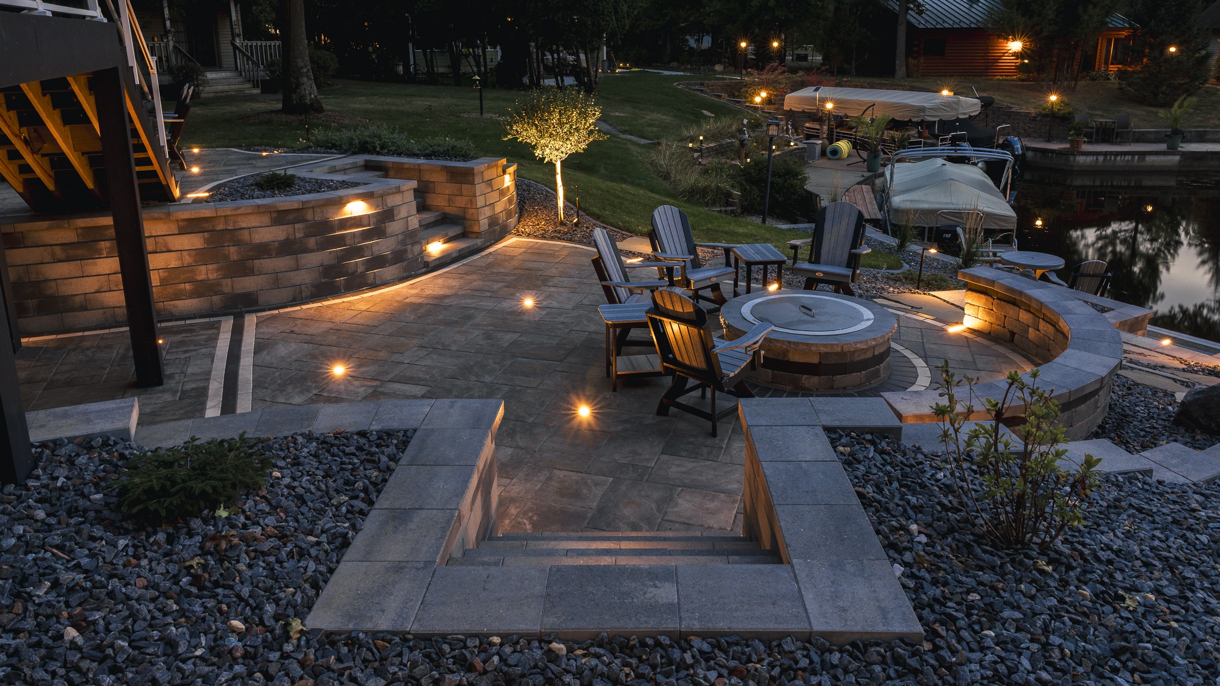 Lakeside patio with fire pit and evening lighting