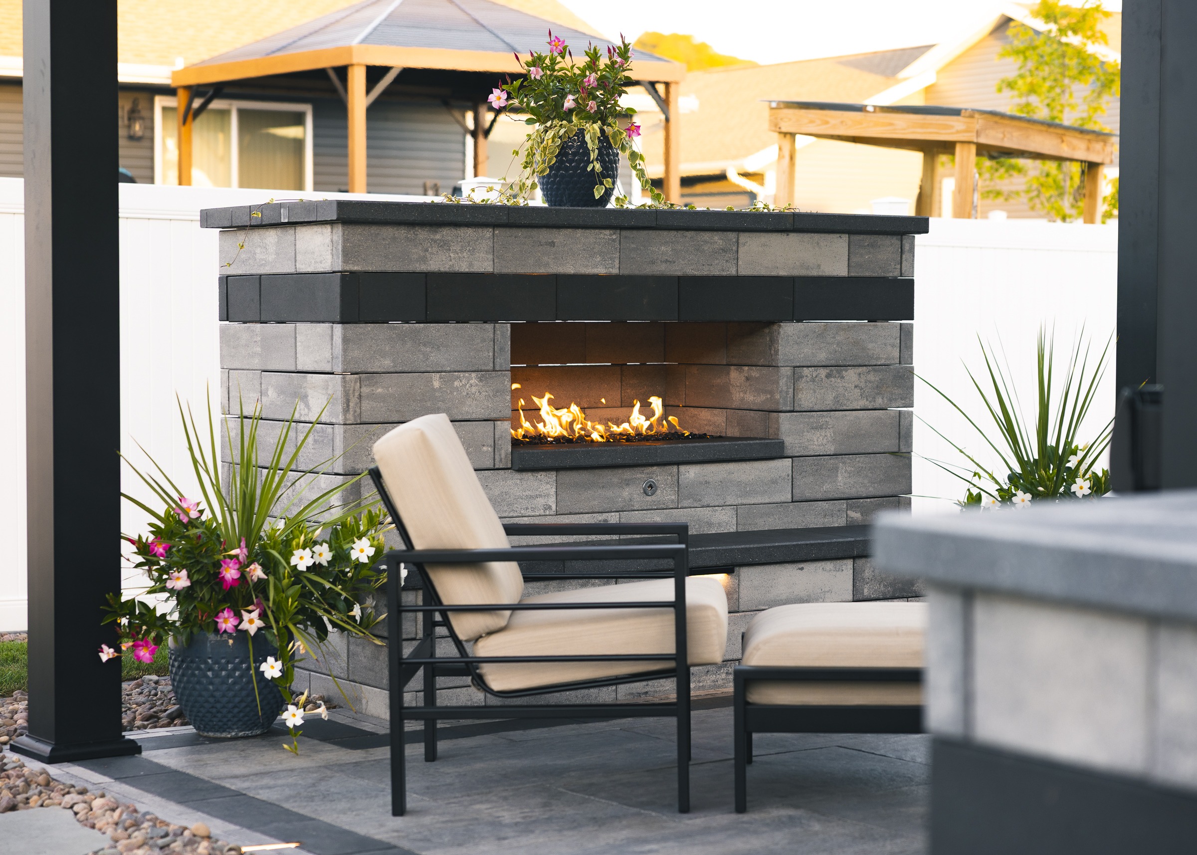 Modern outdoor patio with stone gas fireplace