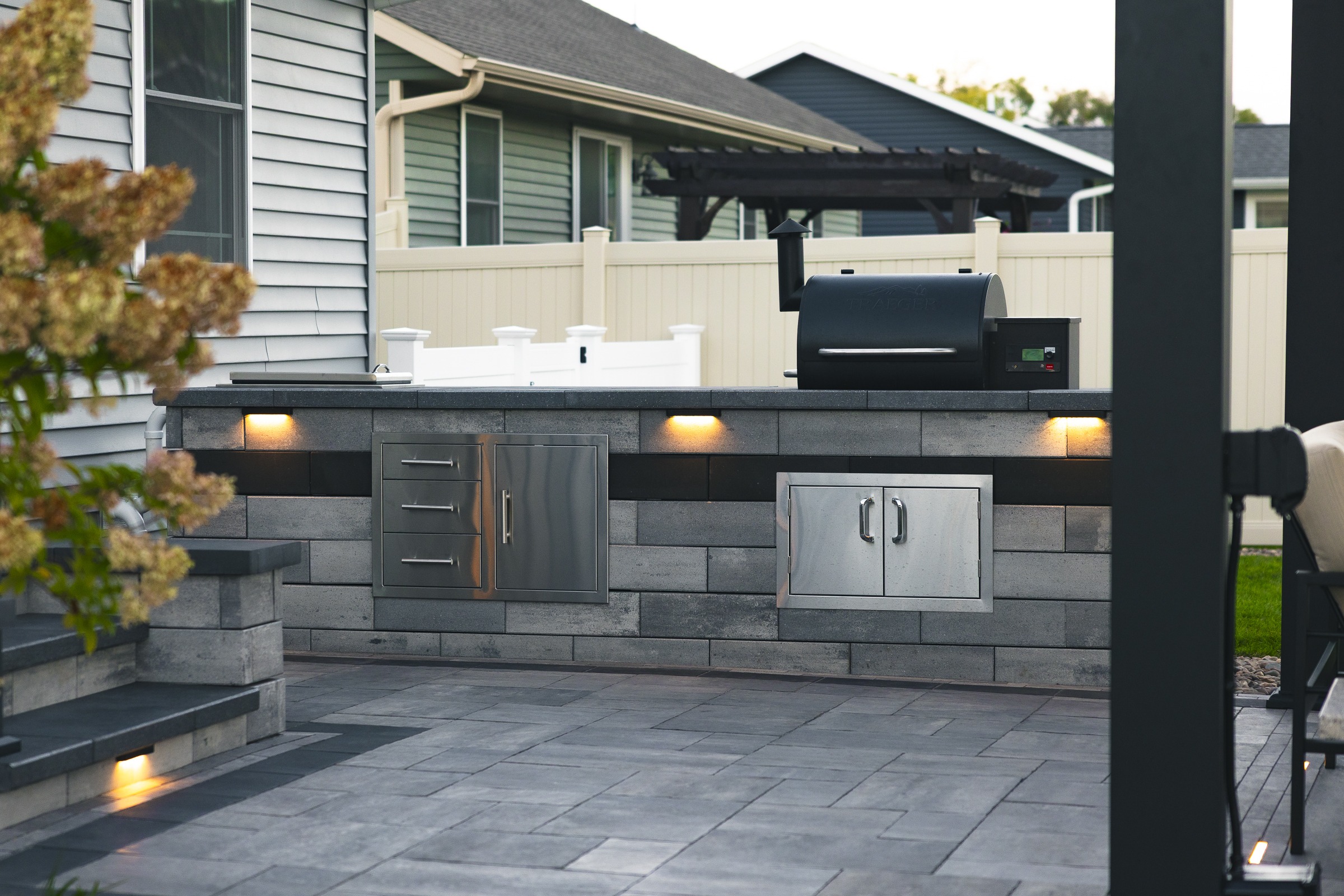 Modern backyard outdoor kitchen with built-in grill