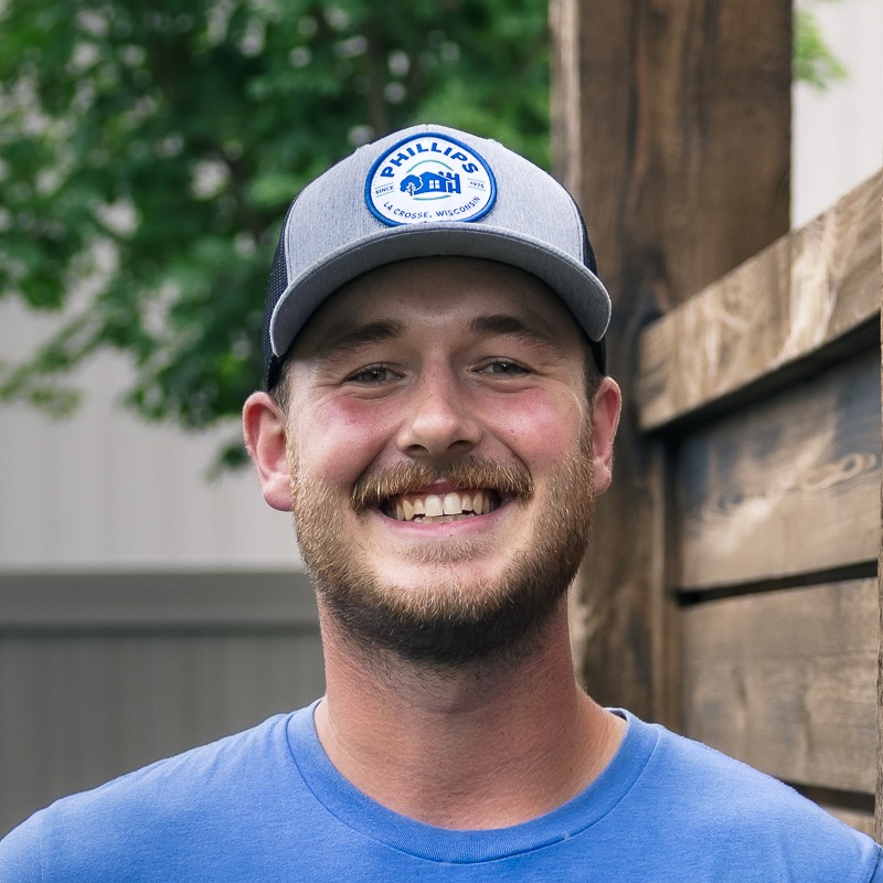 Smiling man in gray cap and blue shirt