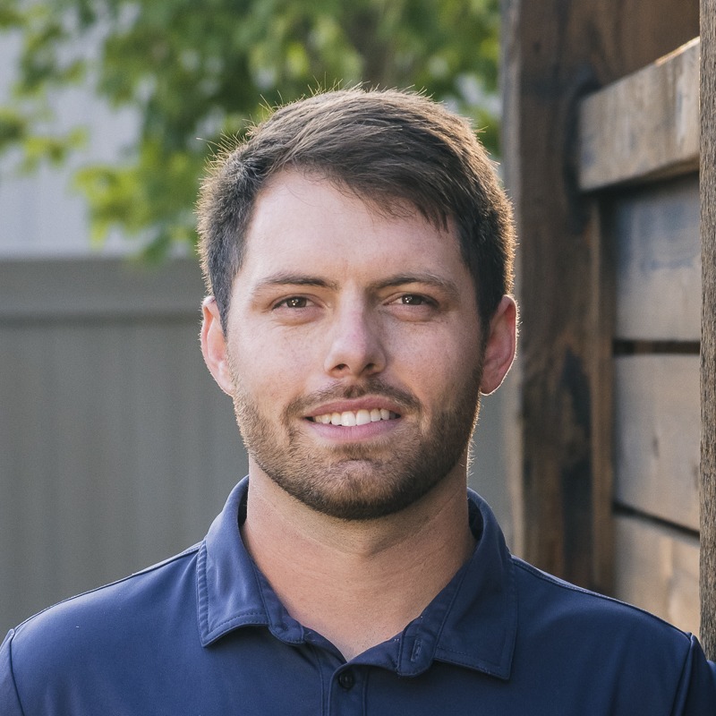 Young man in navy polo outdoors