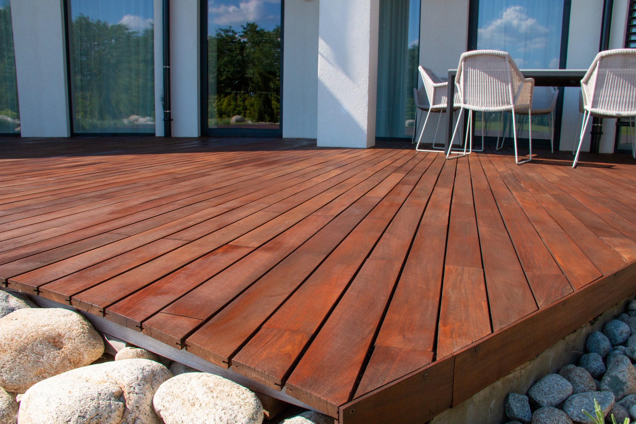 Modern wooden deck patio with outdoor chairs