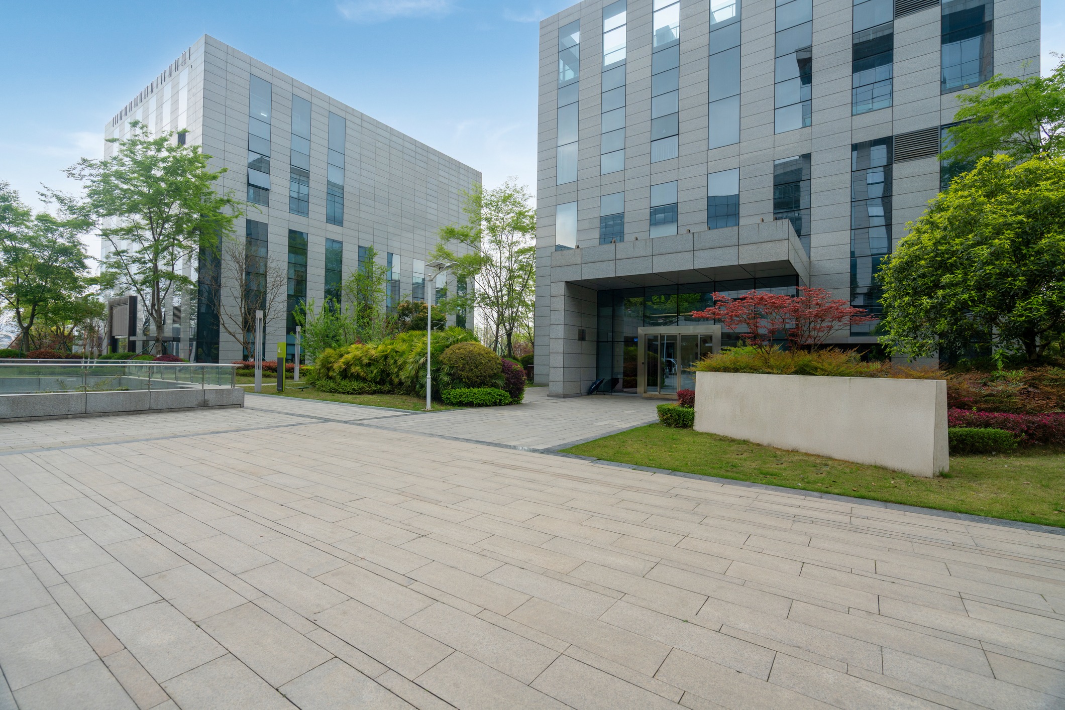 Modern office buildings with landscaped courtyard and walkway
