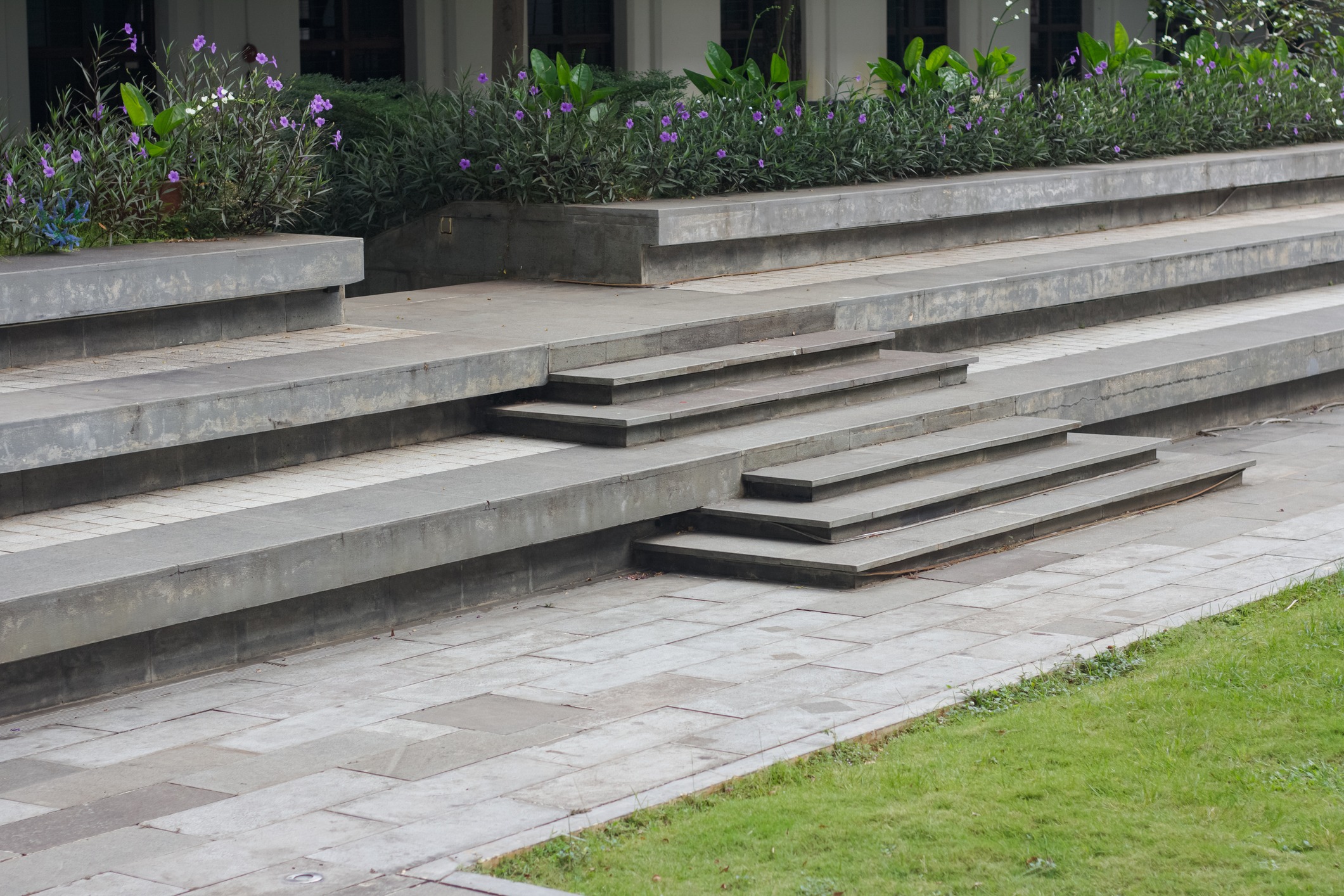 Tiered concrete steps with landscaped flower beds