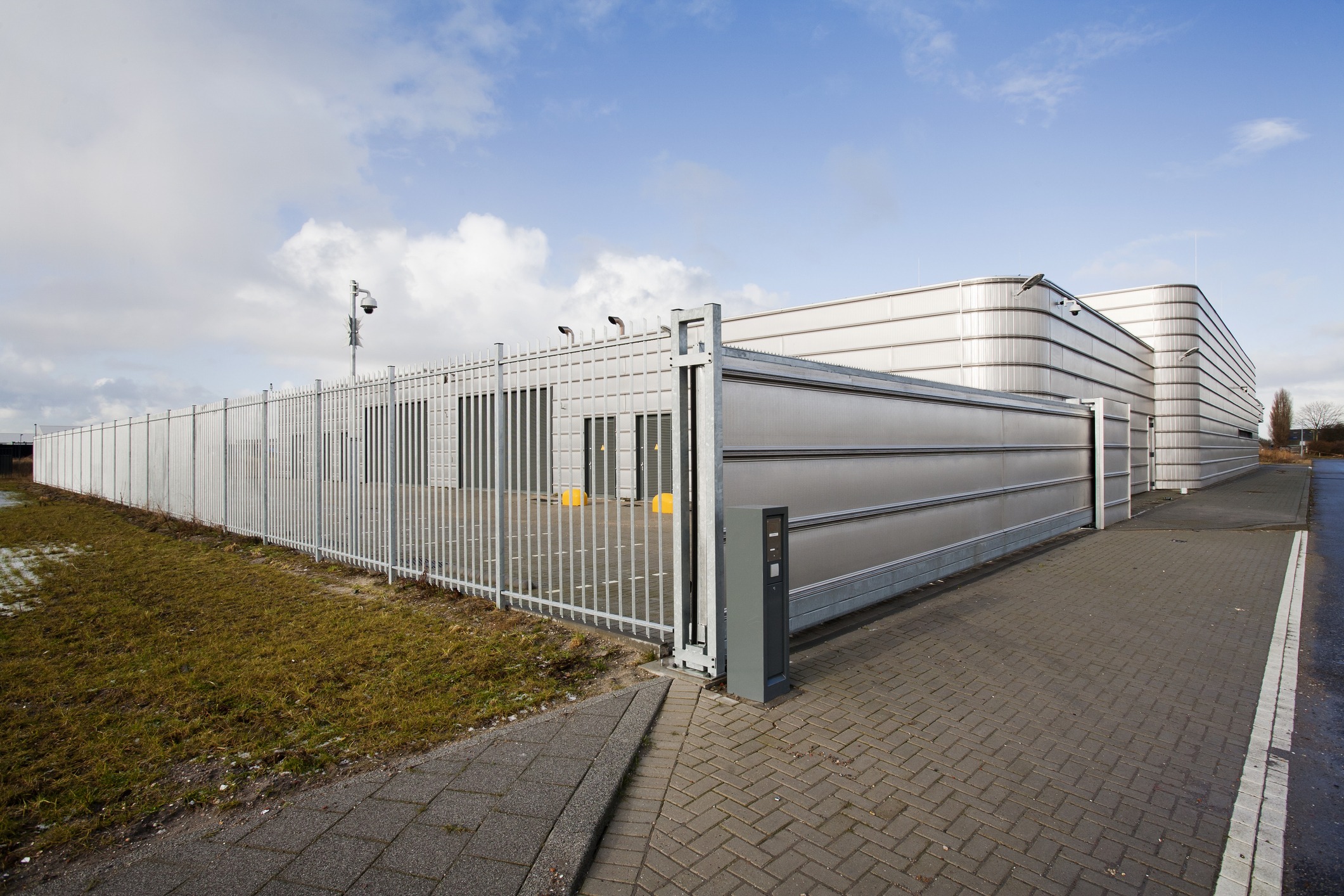 Industrial building with high security fence and gate