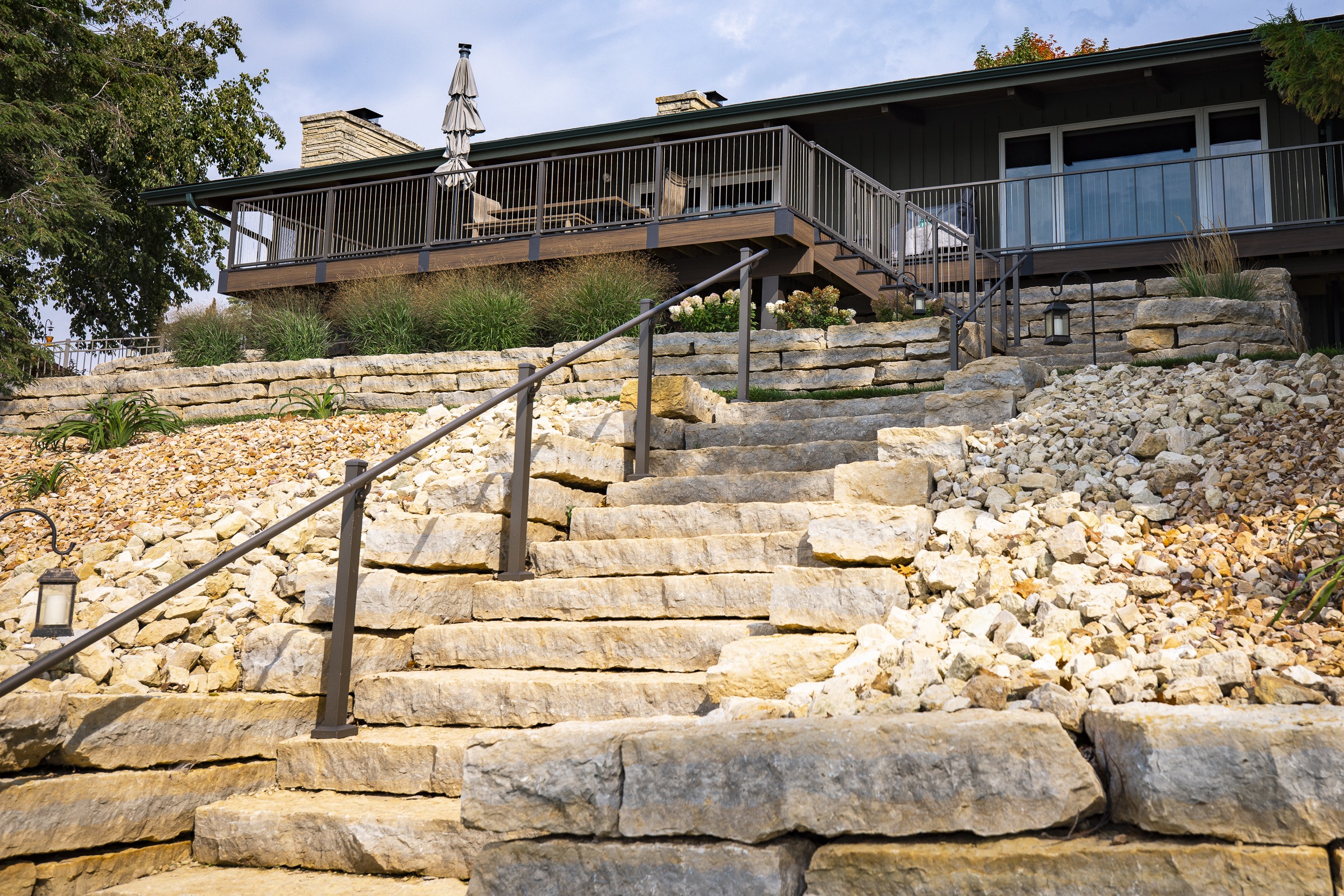 Stone steps leading to elevated backyard deck