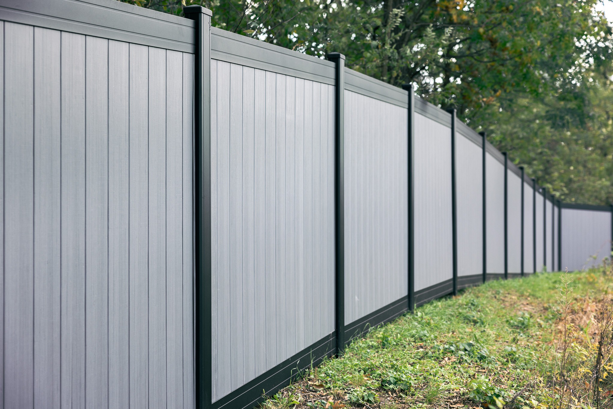 Gray vinyl privacy fence with black posts