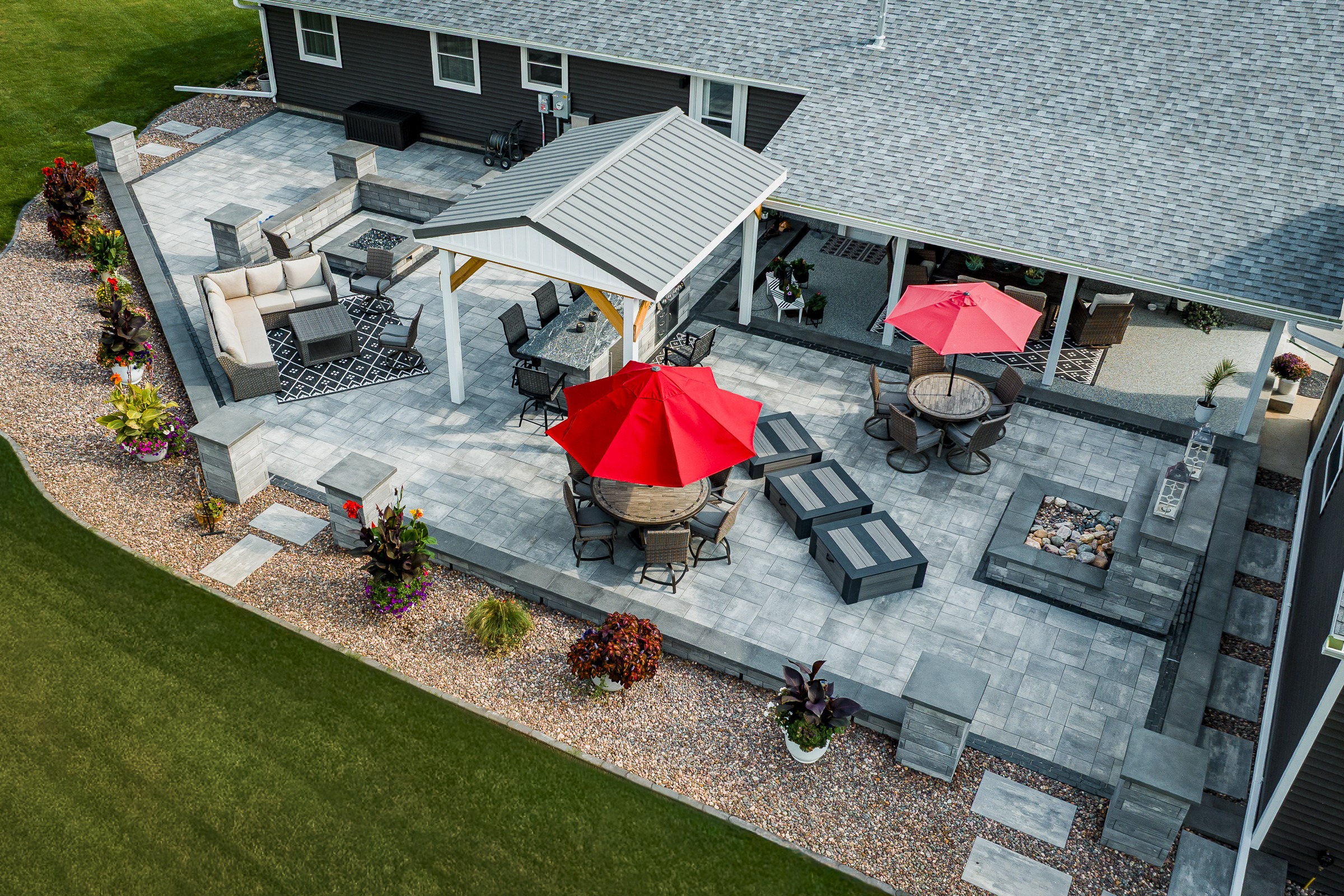 Modern backyard patio with pergola and red umbrellas