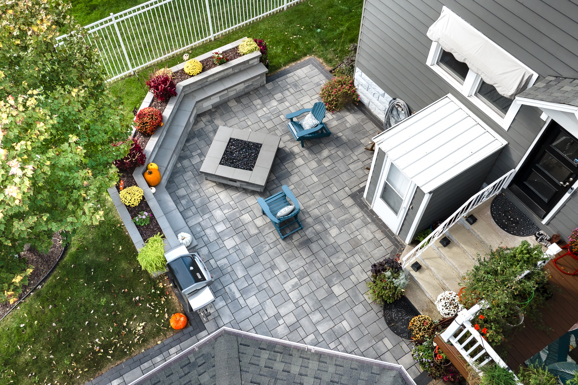 Aerial view of backyard patio with fire pit