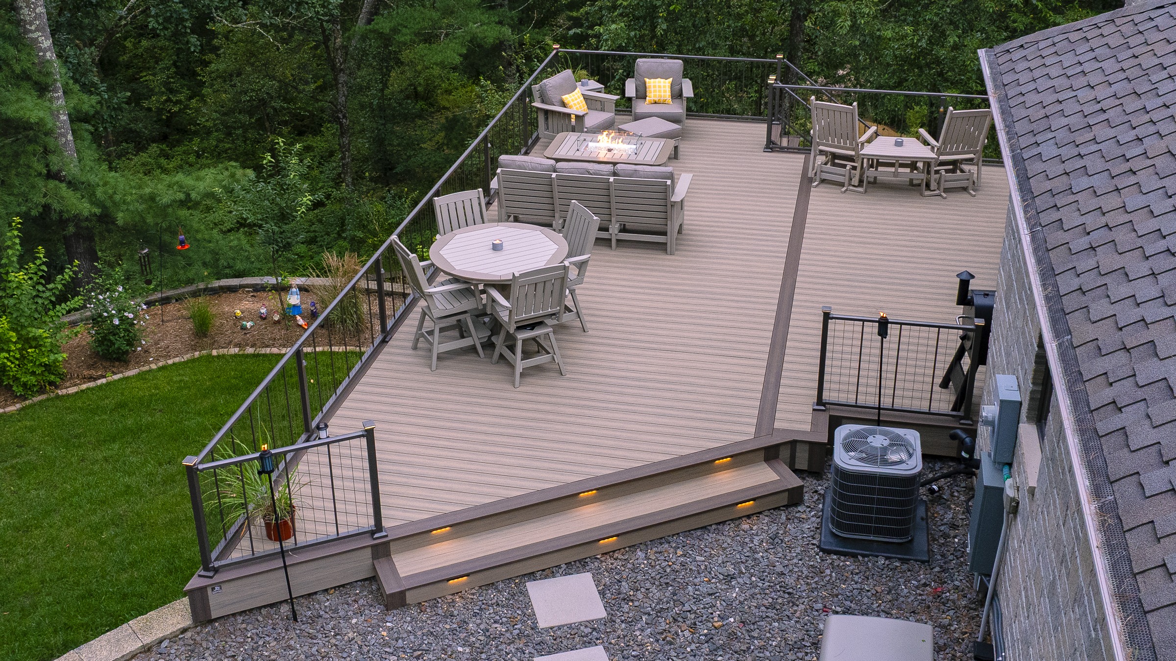 Spacious elevated backyard deck with seating and fire pit