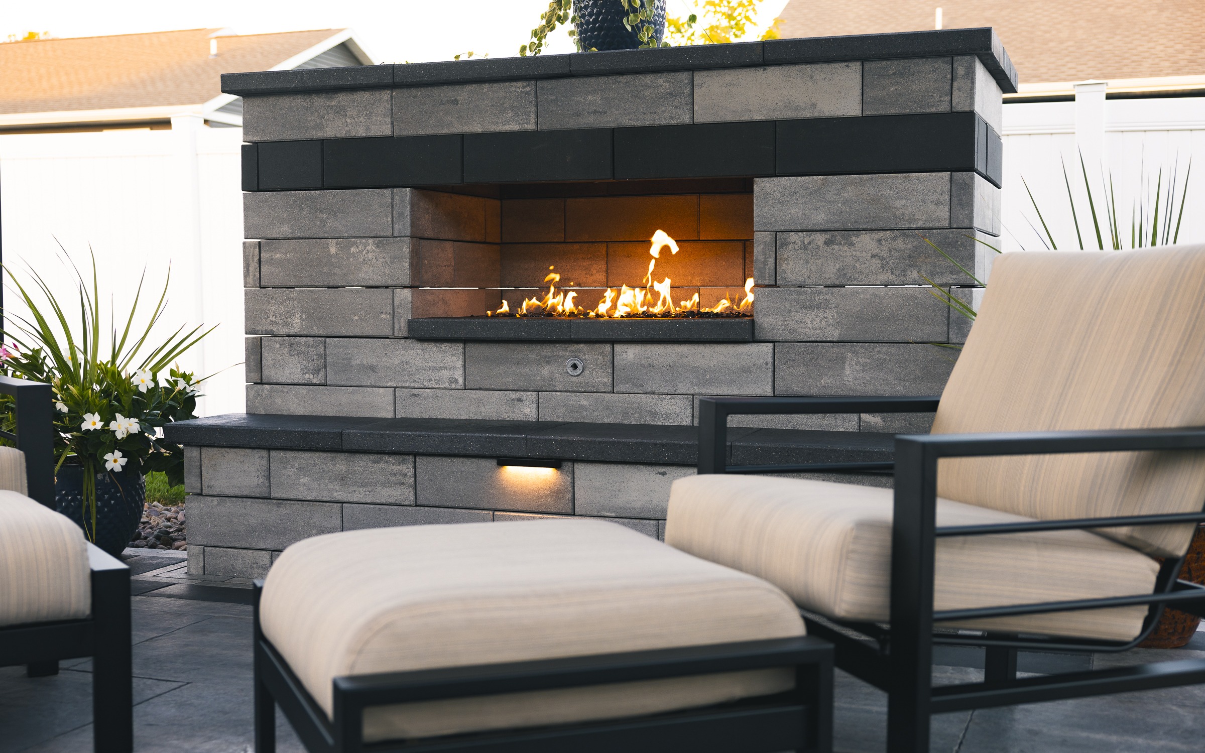 Modern outdoor patio with stone fireplace and seating
