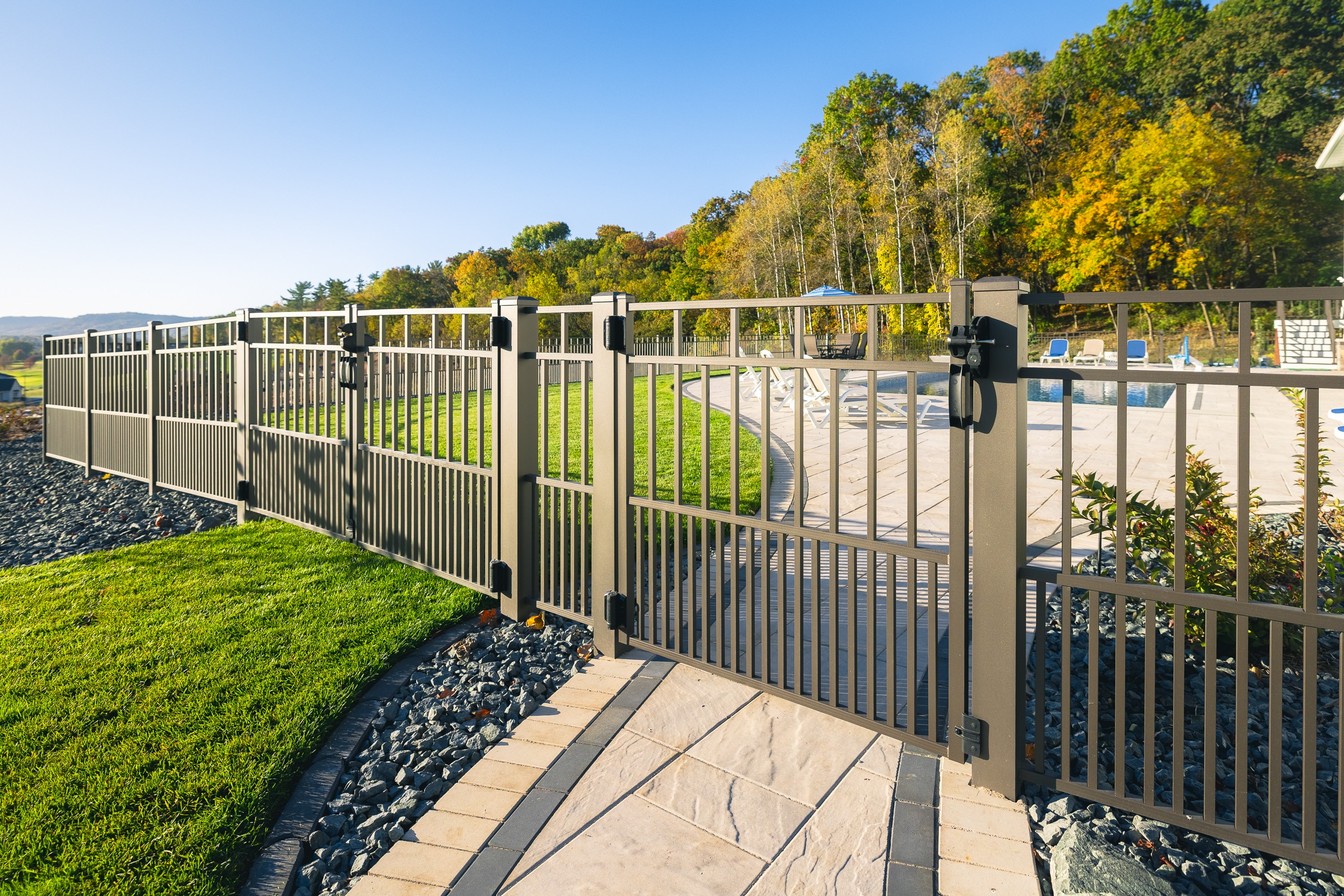 Metal fence surrounding backyard swimming pool area