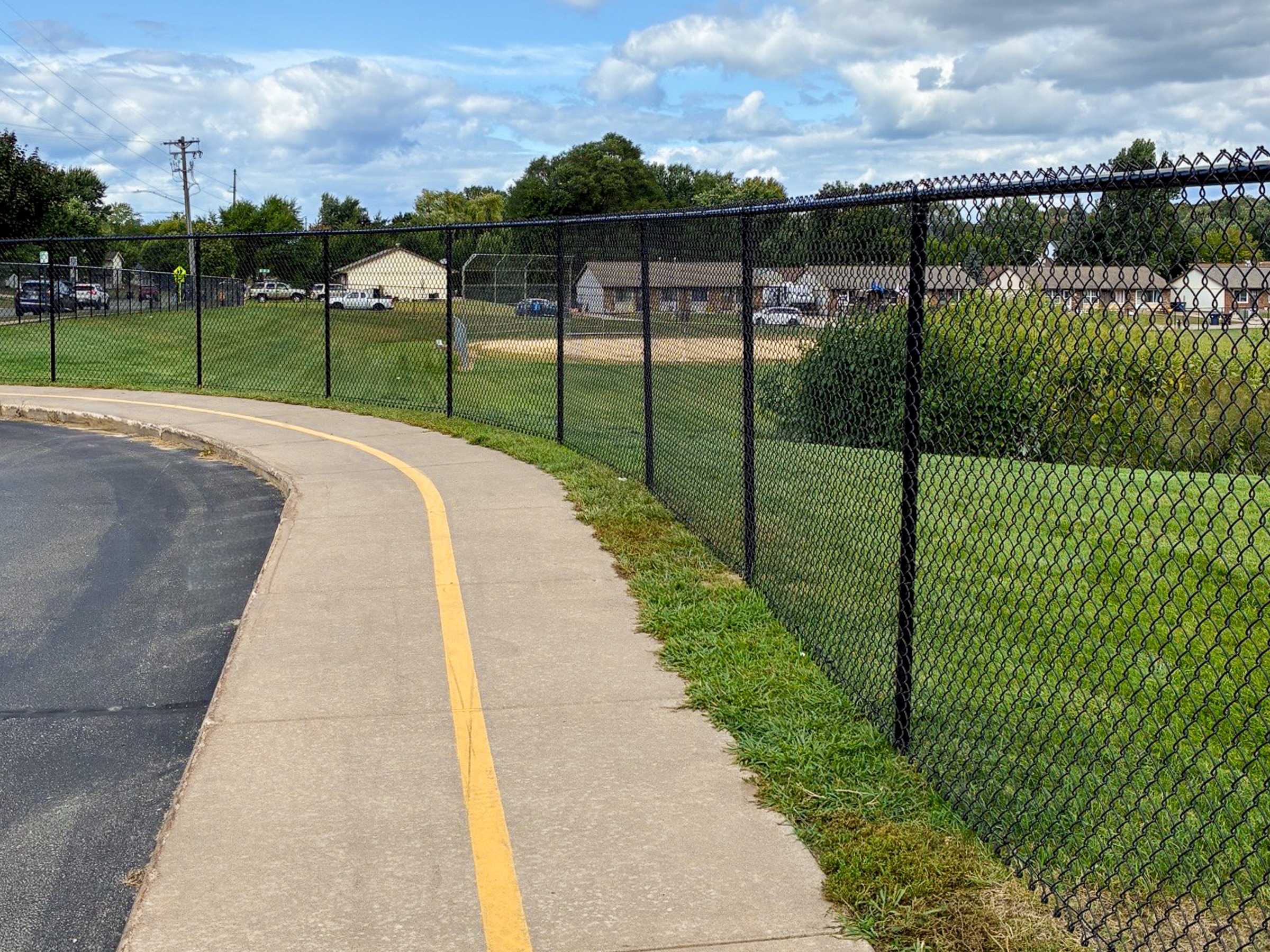 Black chain-link fence installed at Northern Hills Elementary School providing secure containment for outdoor play areas.