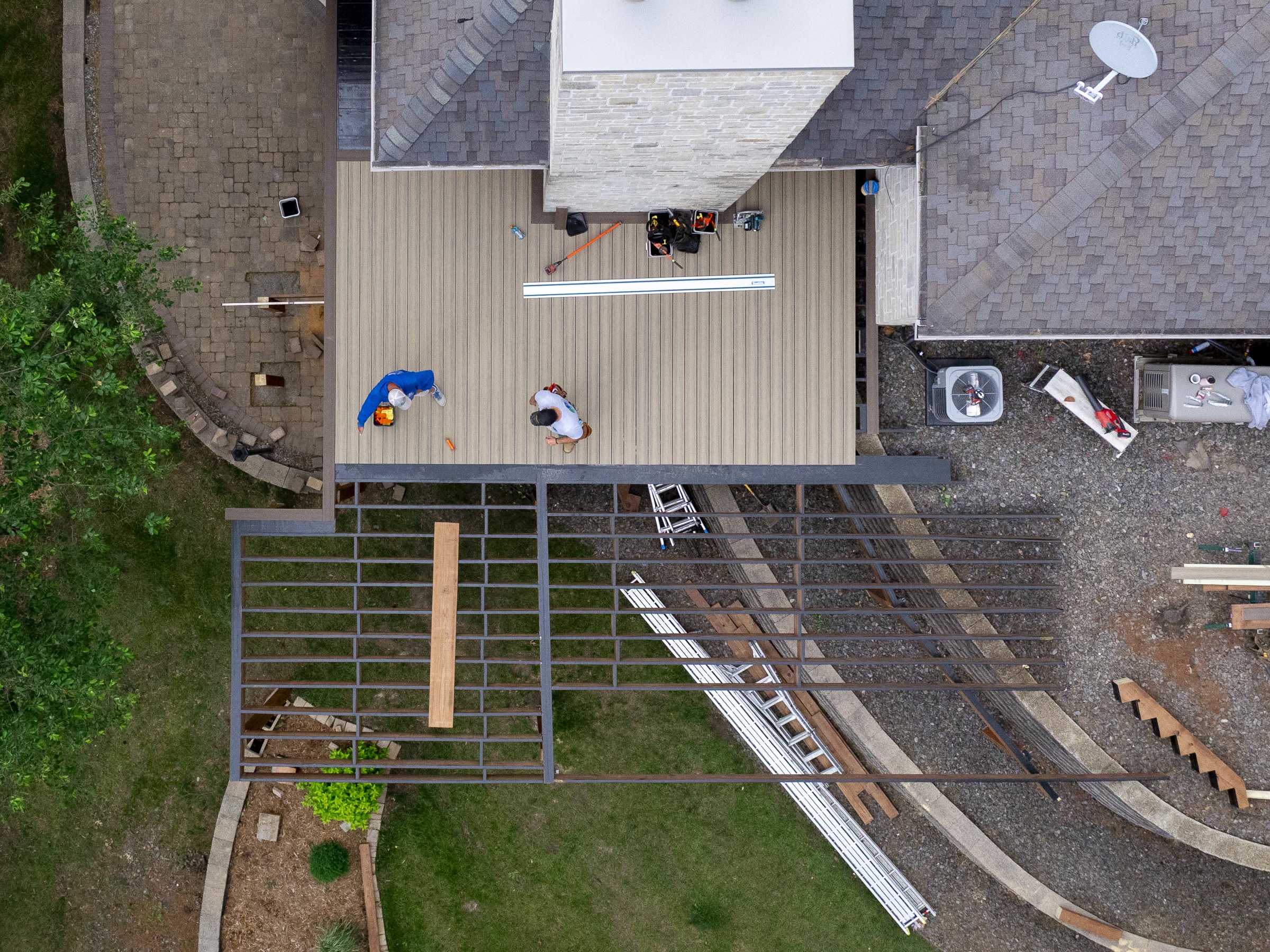 Aerial view of workers building backyard composite deck