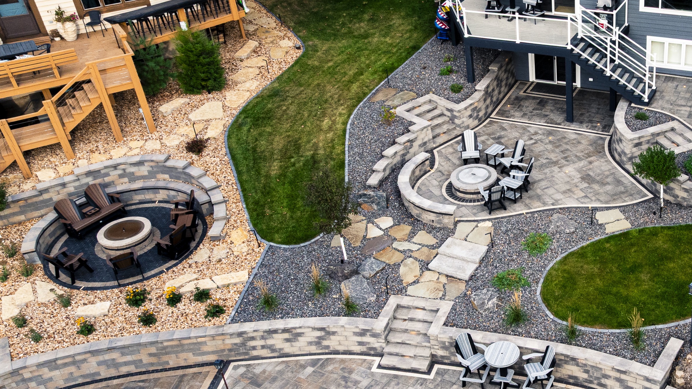 Aerial view of landscaped backyard with patios and fire pits