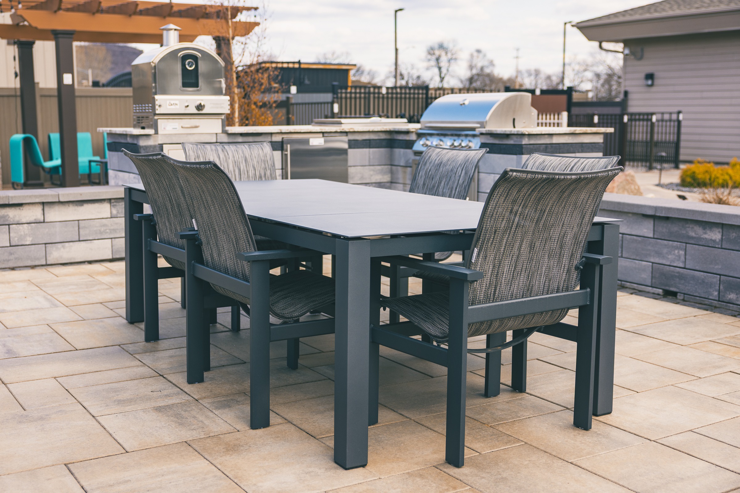 Outdoor patio dining set with grill and pizza oven