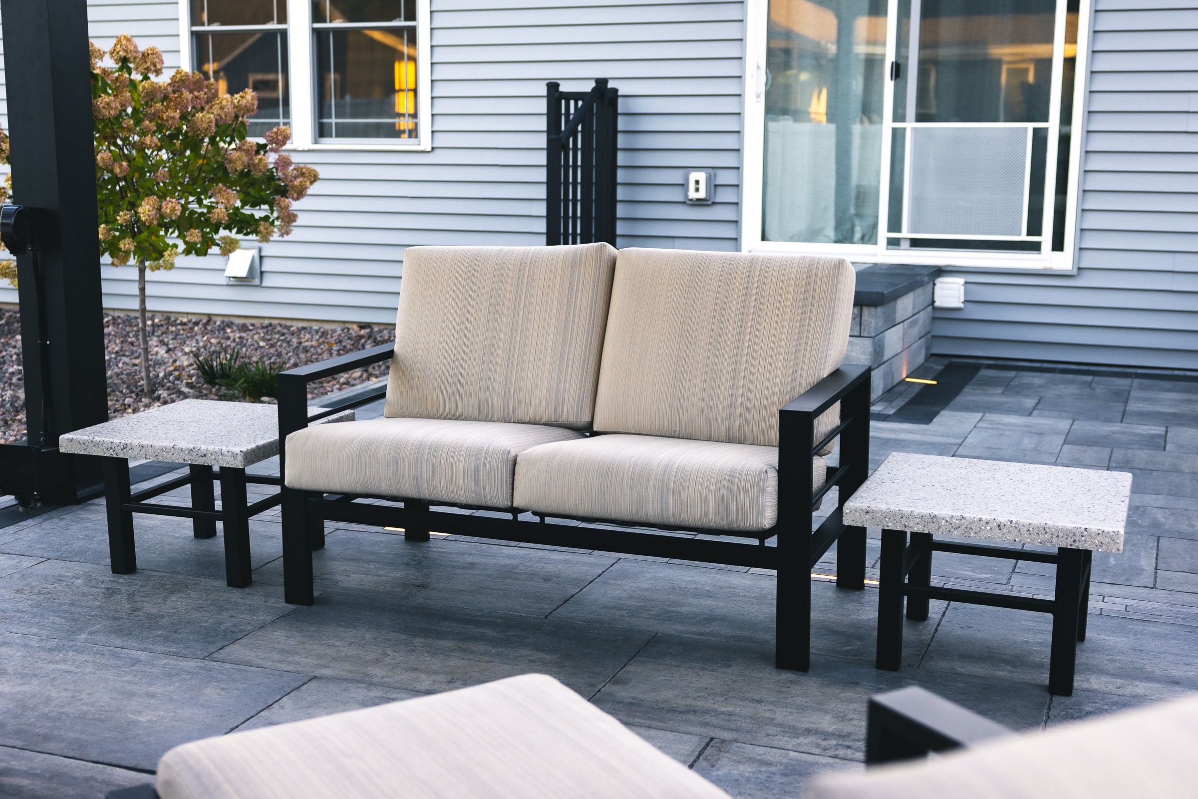 Modern outdoor loveseat on backyard patio