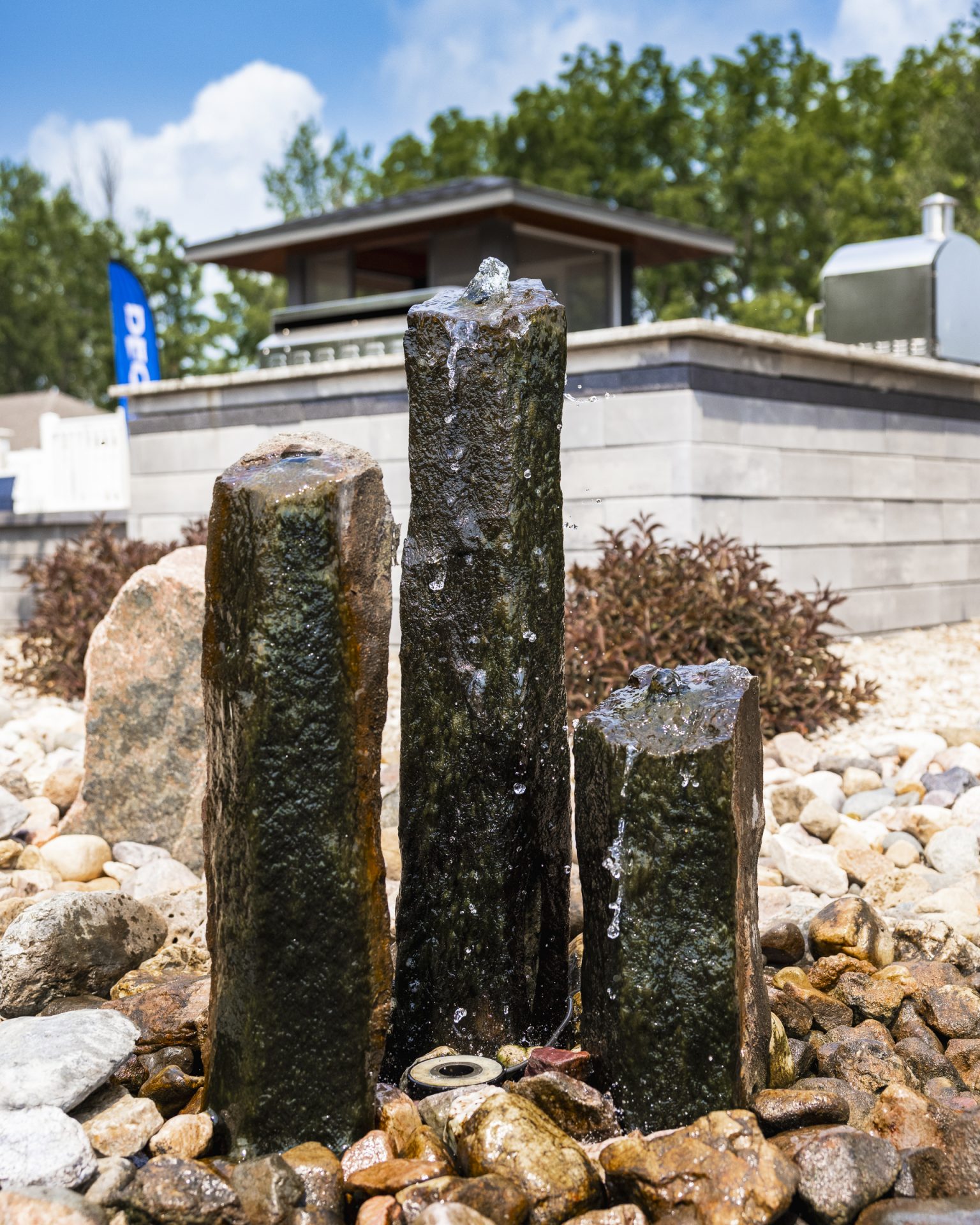 Mongolian Basalt column fountain in landscaped backyard