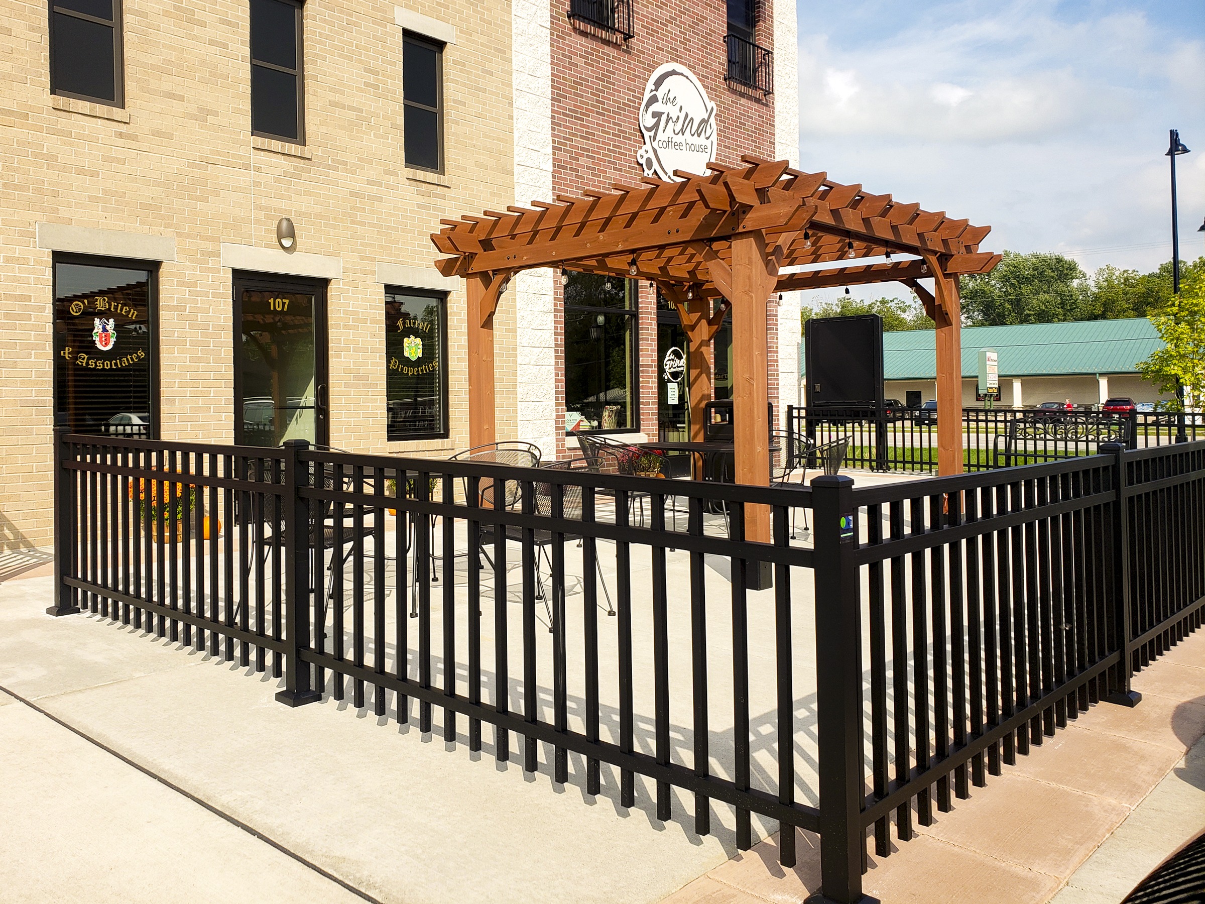 Outdoor patio at The Grind in Holmen, WI with an aluminum fence around the patio.