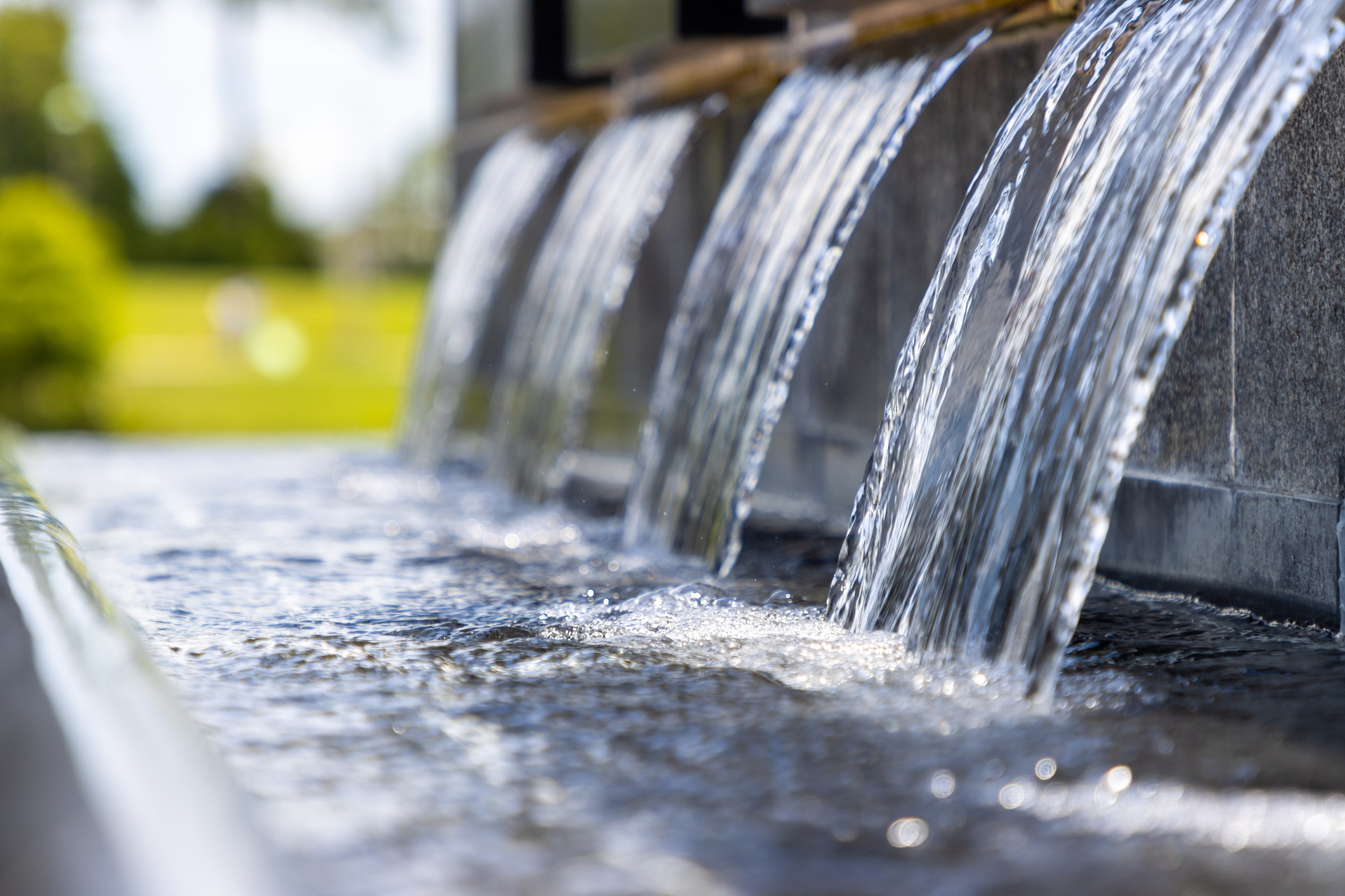 Water cascading from modern stone fountain