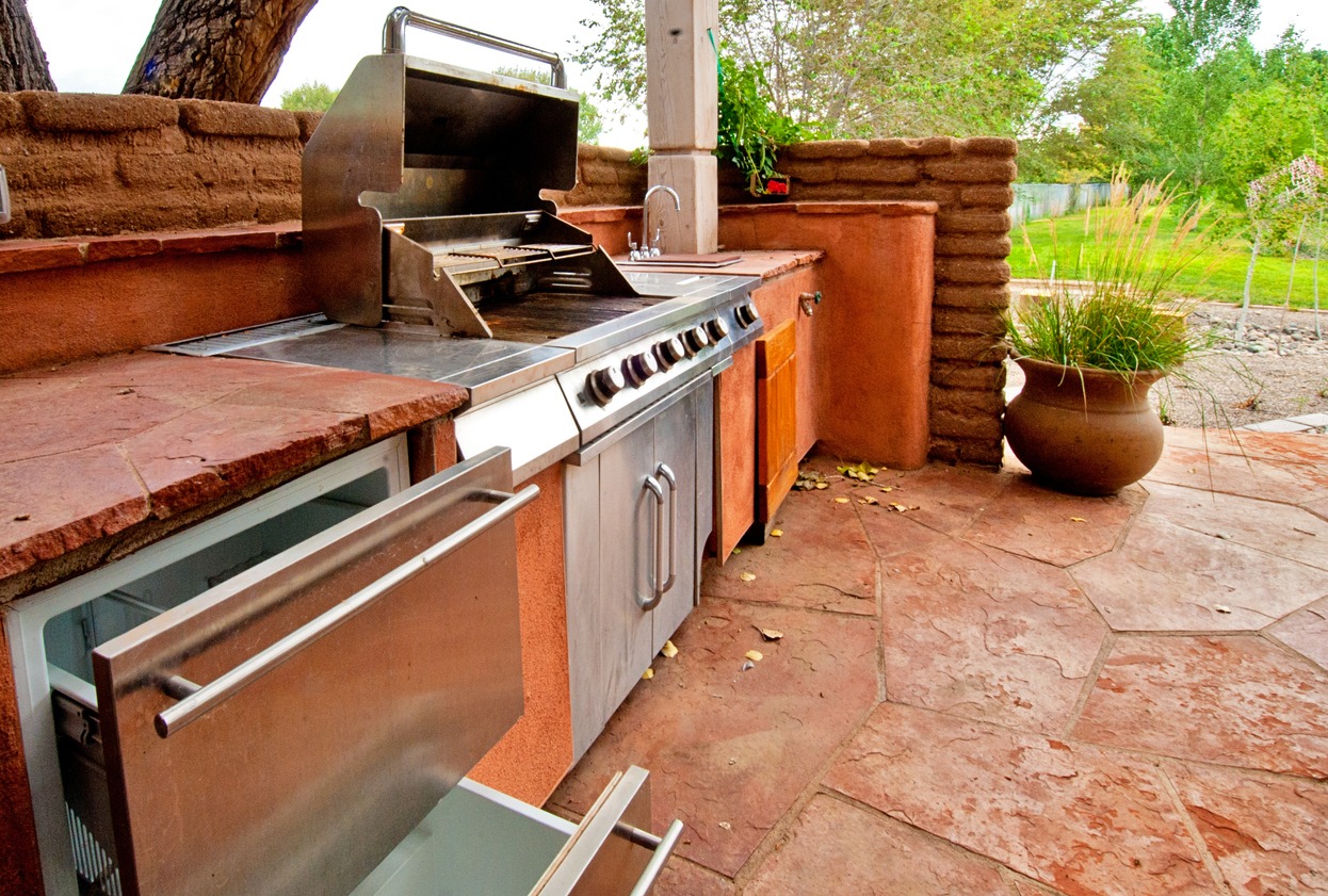 Outdoor kitchen with stainless steel grill and patio
