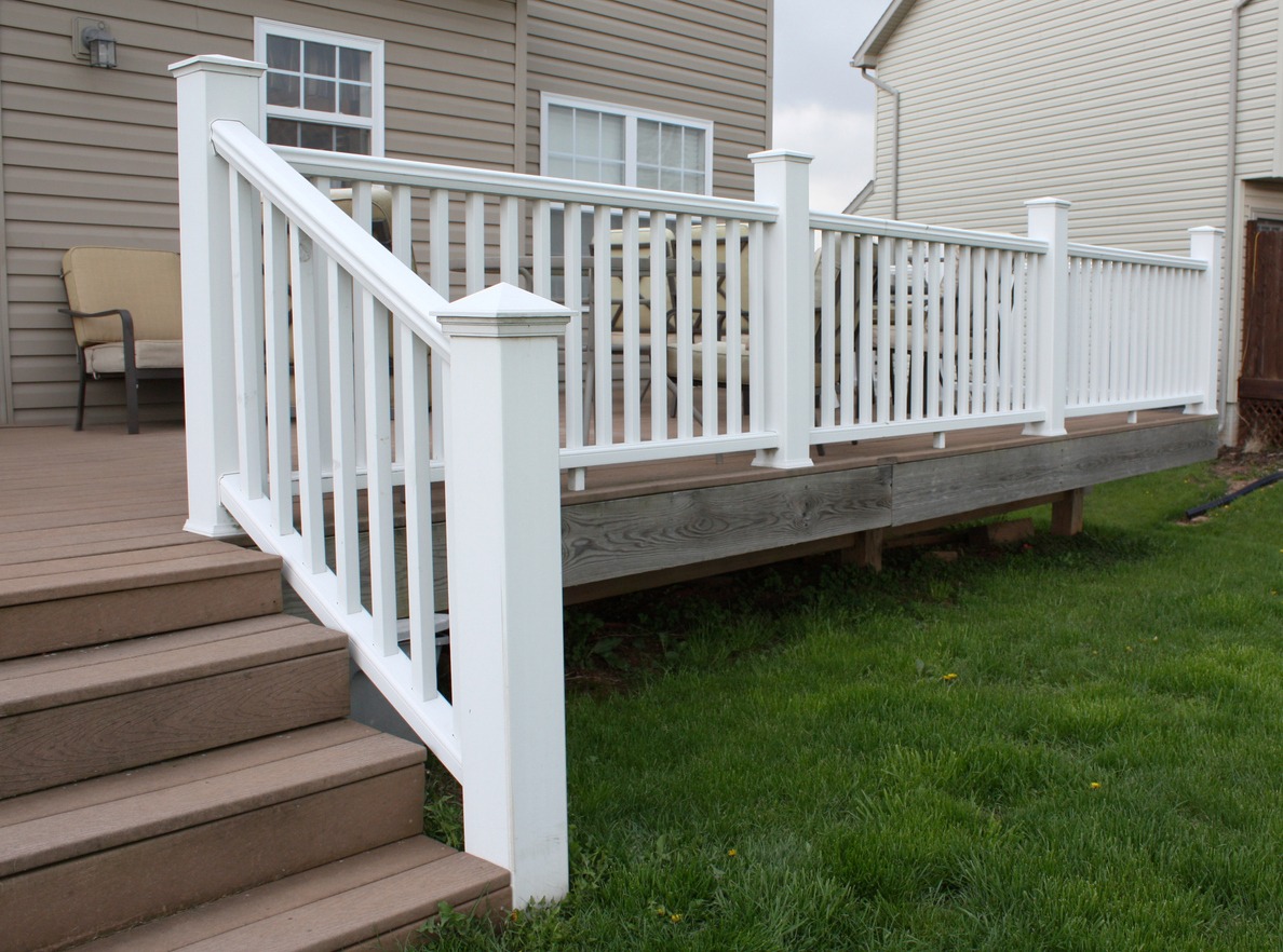 White railing on backyard wooden deck stairs